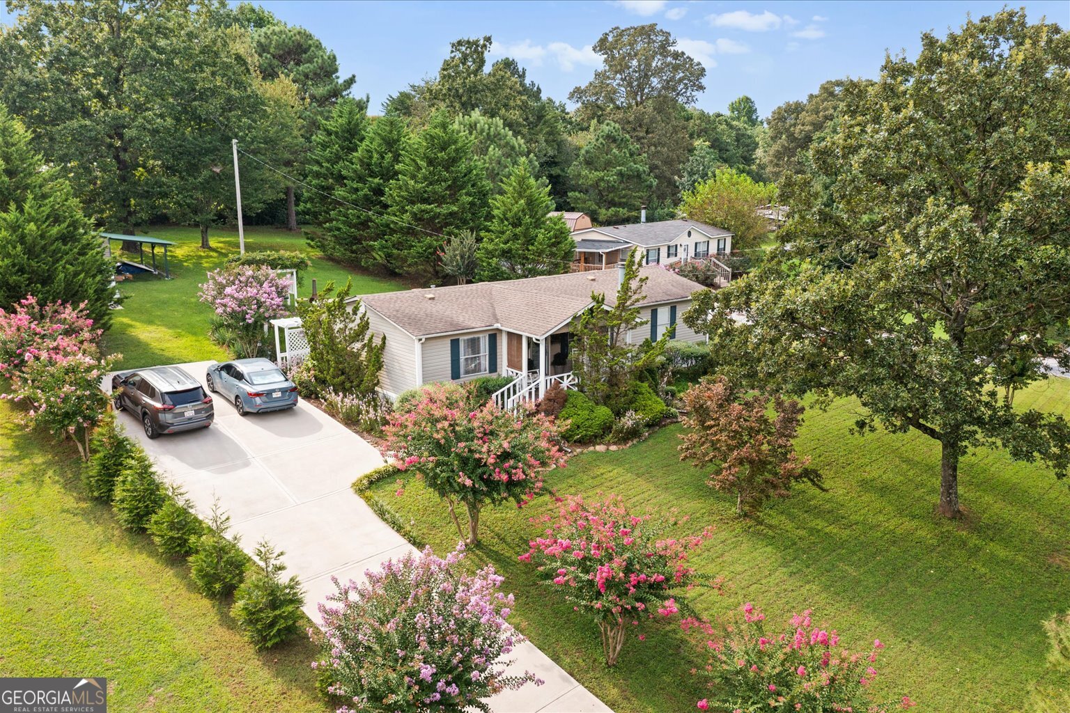 Beautifully maintained and truly one of the most well-cared-for properties you'll find! Custom finishes include a real wood-burning chimney, crown molding, custom-framed windows and window stools, and premium wooden blinds. Kitchen features a porcelain backsplash from a $500k home, all-new stainless steel appliances, and luxury LTV floors, with engineered hardwood in living areas and ceramic tile in baths. Outside offers a new covered porch, cozy front porch with fan, two arbors, custom driveway gate, and extravagant landscaping with like-new concrete driveway. A 16x14 workshop/storage building provides power, fans, workbench, and security camera. This home is move-in ready and already feels perfectly like home!