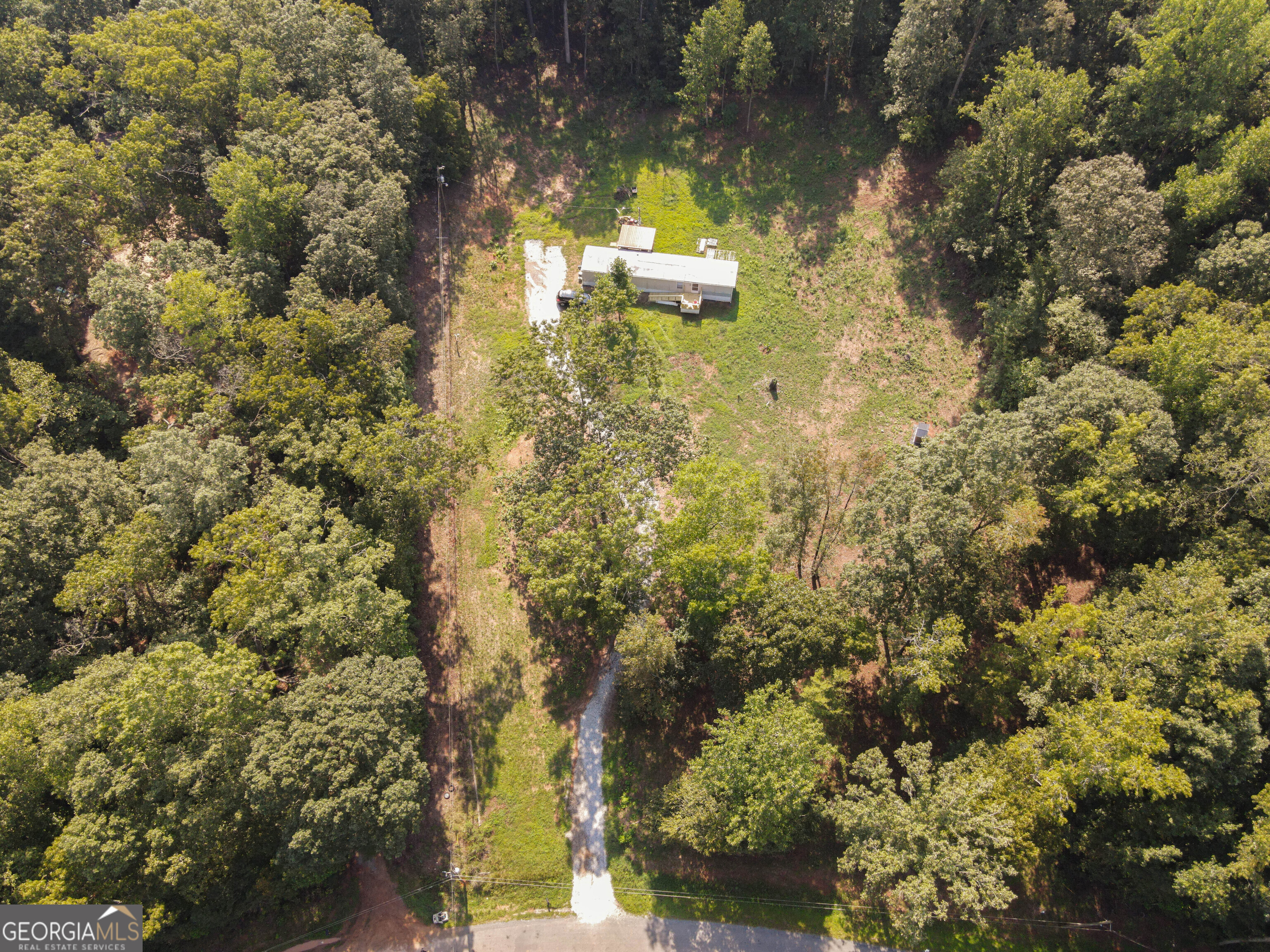 Your Private Paradise Awaits on 2.12 acres in Madison County! 2 bedroom, 2 bathroom mobile home on foundation. Brand new well pump, all new plumbing. New 6 x 8 front porch with ramp. 12 x 12 back porch. New ductwork already in place for new system installation. Hardwood floors main living areas. Spacious bedrooms. Lot recently cleared and seeded with grass. Septic system recently serviced. Large, private lot.