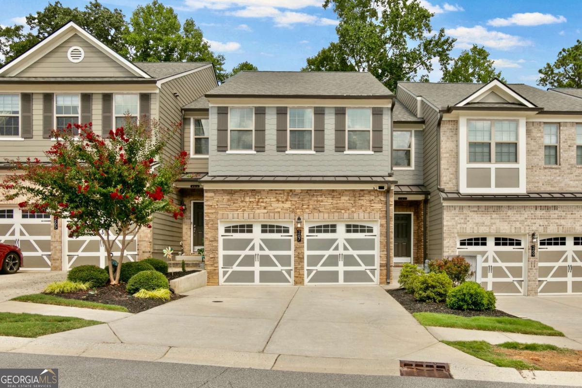 Updated Luxury Townhome close to Downtown Woodstock! 4 Bedrooms and 3.5 Baths. The Covered Front Porch welcomes you. Open Concept Floor Plan with Soft Neutral Colors, Updated Fixtures, Plantation Shutters and Hardwood Floors throughout Main Level. Modern Kitchen features Granite Counters, White Cabinets, Tile Backsplash & Large Center Island. Separate Dining Area. Spacious Family Room with Great Natural Light and Gas Logs Fireplace. Hardwood Stairs lead you to a Split Bedroom Plan with Spacious Primary Suite including Large Master Closet. Master Bath boasts Double Vanity with Granite Counters and Large Walk-in Shower. Separating Bedrooms is a Cozy Loft Area for TV, Gaming, Reading, etc. Secondary Bedrooms have Walk-in Closets and Adjacent Full Bath. Large, Open Finished Basement for 4th Bedroom and Full Updated Bath. This area includes Office Nook for Quiet and Privacy. There is also Plenty of Storage Space with Multiple Oversized Closets. Basement walks out to a Shaded Patio and Green Space Perfect for Kids and Pets. There is also an Extended Double Size Private Balcony for Quiet Evenings & Saturday Morning coffee. Property within easy walking distance of Ample Overflow Parking. Stoney Creek is a Manicured, Walkable Community with a Beautiful Pool. HOA covers Grounds Maintenance, Dwelling Exterior, Roof, Swim, Etc. Fee Simple Townhome. Great Woodstock Location near all the shops and restaurants in Downtown. Convenient to Sixes Road and I-575. Sought after Ridgeview High School.