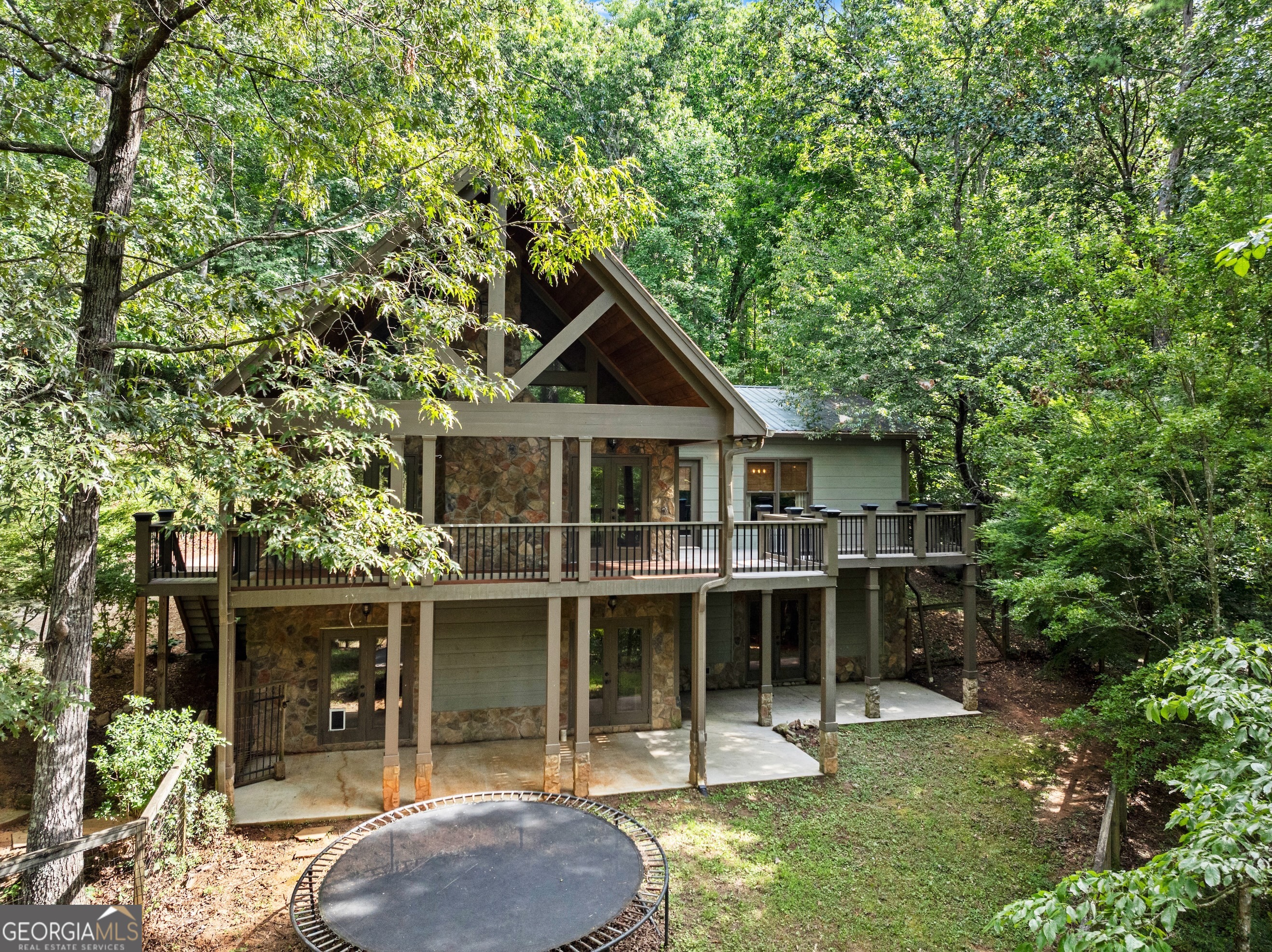 Private Hidden Gem on 2.54 Acres - No HOA! Discover the perfect blend of privacy, convenience, and charm with this hidden gem nestled on 2.54 wooded acres-just 5 minutes from GA 400, top-rated restaurants, shopping, schools, and parks. Tucked away in a serene, natural setting, this peaceful retreat features a beautiful pond and fenced backyard, creating a private oasis for outdoor living. Inside, you'll love the open-concept design that seamlessly connects the kitchen, dining, and living areas-ideal for entertaining or cozy evenings at home. A stunning stone fireplace serves as the heart of the living room, while Trex decking and a covered back porch invite you to enjoy the surrounding nature in any weather. The oversized master suite is a true retreat, featuring a beautiful tile shower, double vanities, and a spacious walk-in closet. Downstairs, the full unfinished basement-with its own exterior entrance-is already stubbed for a kitchen and bath, offering endless potential for a guest suite, rental, or multi-generational living. No HOA restrictions mean more freedom to make this property your own. Whether you're looking for a quiet escape, room to grow, or a place to enjoy the outdoors, this one-of-a-kind property has it all. Welcome home to your wooded sanctuary!