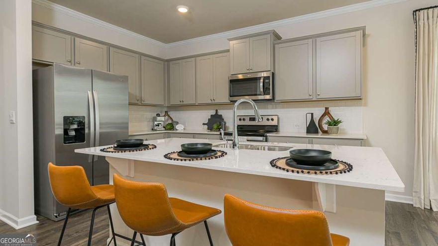 The Salisbury Floor Plan is a newly constructed, two-story townhome designed for modern living. This spacious home features three bedrooms, 2.5 bathrooms, and a two-car garage. The open-concept main floor boasts a stylish kitchen with 42C cabinets, crown molding, a chic tile backsplash, and elegant quartz countertops. The space flows seamlessly into a cozy living area and a dining spaceCoperfect for entertaining. Upstairs, two secondary bedrooms share a convenient Jack-and-Jill bathroom and offer generous walk-in closets. The primary suite serves as a private retreat, complete with an en-suite bath and a spacious walk-in closet. With contemporary finishes, ample storage, and a low-maintenance exterior, this townhome blends comfort and functionality in a prime Barrett Parkway locationCojust minutes from parks, dining, and shopping.