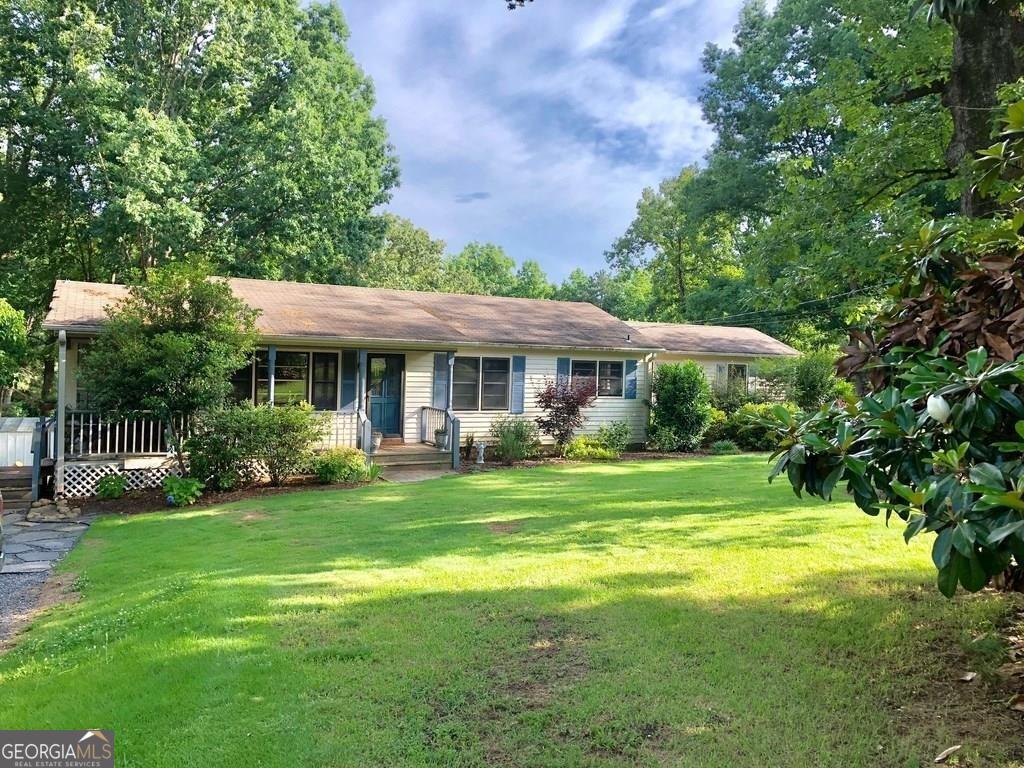 Highly desirable Milton community home nestled on a spacious 1-acre lot, presenting a prime investment opportunity with the potential to construct your dream home in the future. This charming 3 Bedroom, 2 Bath residence is conveniently located on Hopewell Road, just a stone's throw away from the prestigious Manor Country Club and surrounded by an enclave of multi-million dollar homes with highly acclaimed sought after schools. No HOA and an ideal canvas awaits on this level lot, offering the perfect foundation for crafting your future custom home.