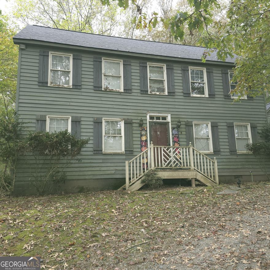 Don't wait on this one, we have already received an offer on day 1 of being active!  Spacious Colonial-Style Home with Endless Potential Nestled just 5 miles from Ellijay, this inviting two-story home offers incredible opportunity and flexibility. Surrounded by nature in a peaceful setting, it's the perfect second home or rental getaway to escape everyday life. From the side entrance, you'll find a full bathroom with a stand-up shower conveniently located across from the laundry room-which also offers space to add a sink or convert into a mudroom. The kitchen provides everything you need for comfortable everyday living, featuring a pantry with pegboard storage for pots and pans, tile countertops, a built-in microwave, white appliances, and a garbage disposal, and a stylish mix of light upper cabinets some with glass fronts and dark lower cabinets for contrast. The layout includes space for a small table. From the kitchen, you can enter the den or access the spacious dining room through a separate doorway. The den features a door leading to the back deck for easy indoor-outdoor flow and includes a walk-in closet, making it suitable as a fourth bedroom if desired. Just beyond, the parlor area adds character and versatility, connecting seamlessly to the den and foyer-perfect for entertaining or creating a cozy reading nook. The dining room is impressive, approximately 400 square feet (20x20), with two walk-in closets for ample storage. The current owner envisioned transforming this space into a primary suite, converting the nearby laundry into a private en suite bath and repurposing the existing full bath across the hall into a new laundry area. Upstairs, you'll find three bedrooms and two full bathrooms. The primary suite features a spacious bedroom and large soaking tub, creating a relaxing retreat. The attic, accessed by disappearing stairs, includes an area with plywood flooring for additional storage. Additional highlights include a new roof, heating and air system, a carriage-style two-car garage with a breezeway, and a space above the garage that could easily be turned into a loft area. Heating ducts can also be extended from the main house for climate control. The property operates on well water and a septic system and sits on a desirable corner lot where the private road meets the main road-offering both privacy and convenience. Located in a resort-style area ideal for a second home, rental, or wooded retreat, this property provides space, flexibility, and the potential to make it your dream getaway.