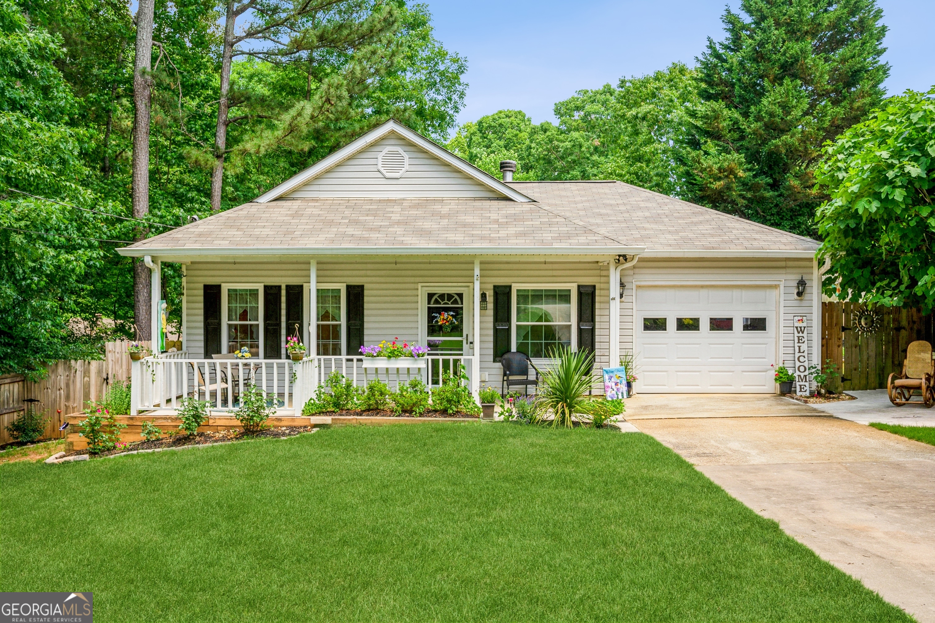 This charming, move-in-ready ranch-style home is just about 3 miles from Lake Lanier, offering easy access to GA400. You'll love the many features here, including a whole-house water softener system, double-pane windows, ceiling fans, a cozy wood-burning fireplace (recently serviced), a new HVAC system, a newer water heater, and a Gutter Guard system. The home features tile and laminate floors throughout, so no carpets! There's also a new sliding door that opens to the back patio, perfect for relaxing or entertaining. The covered front porch invites you to sit and enjoy, while the spacious yard offers plenty of room for gardening and enjoying the recently planted fruit trees. Best of all, there are no HOA or rental restrictions, making this home a wonderful place to settle in.