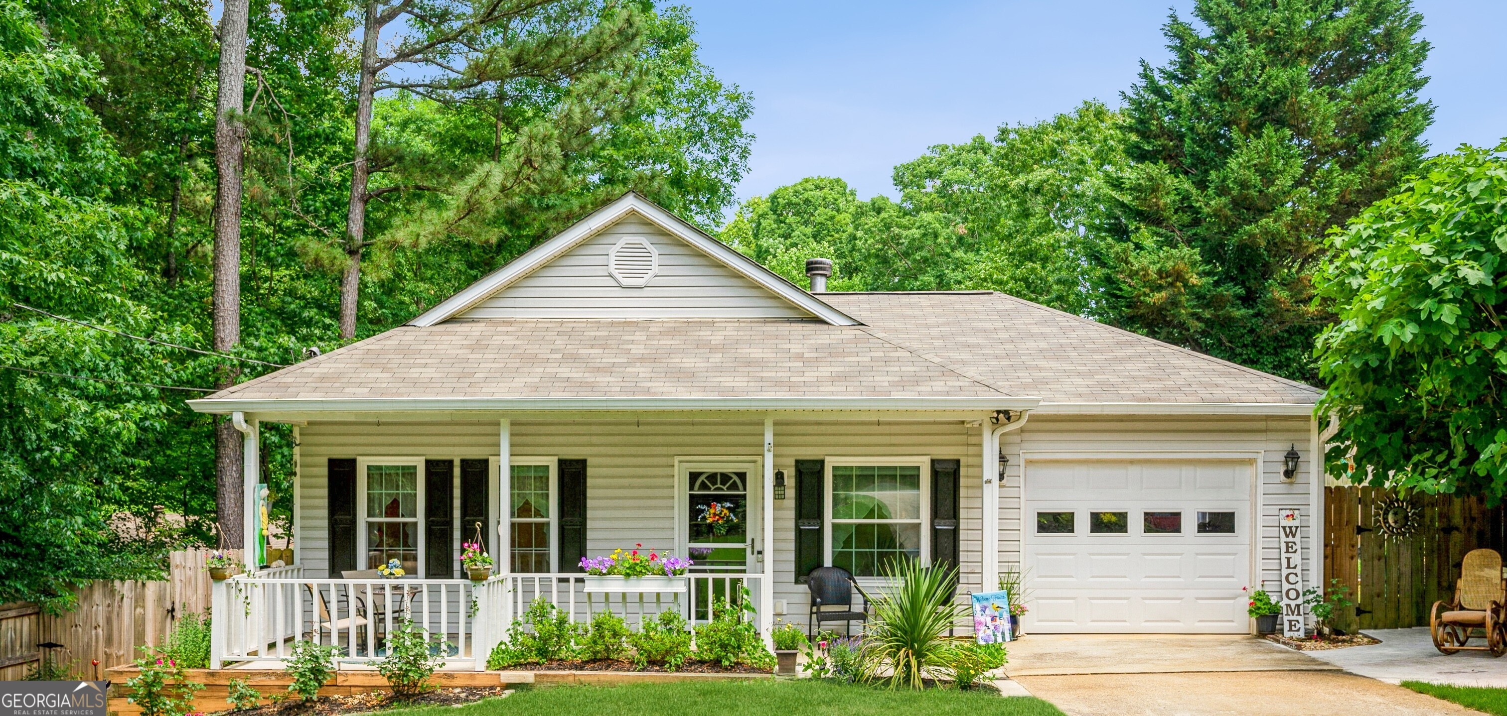 This charming, move-in-ready ranch-style home is just about 3 miles from Lake Lanier, offering easy access to GA400. You'll love the many features here, including a whole-house water softener system, double-pane windows, ceiling fans, a cozy wood-burning fireplace (recently serviced), a new HVAC system, a newer water heater, and a Gutter Guard system. The home features tile and laminate floors throughout, so no carpets! There's also a new sliding door that opens to the back patio, perfect for relaxing or entertaining. The covered front porch invites you to sit and enjoy, while the spacious yard offers plenty of room for gardening and enjoying the recently planted fruit trees. Best of all, there are no HOA or rental restrictions, making this home a wonderful place to settle in.