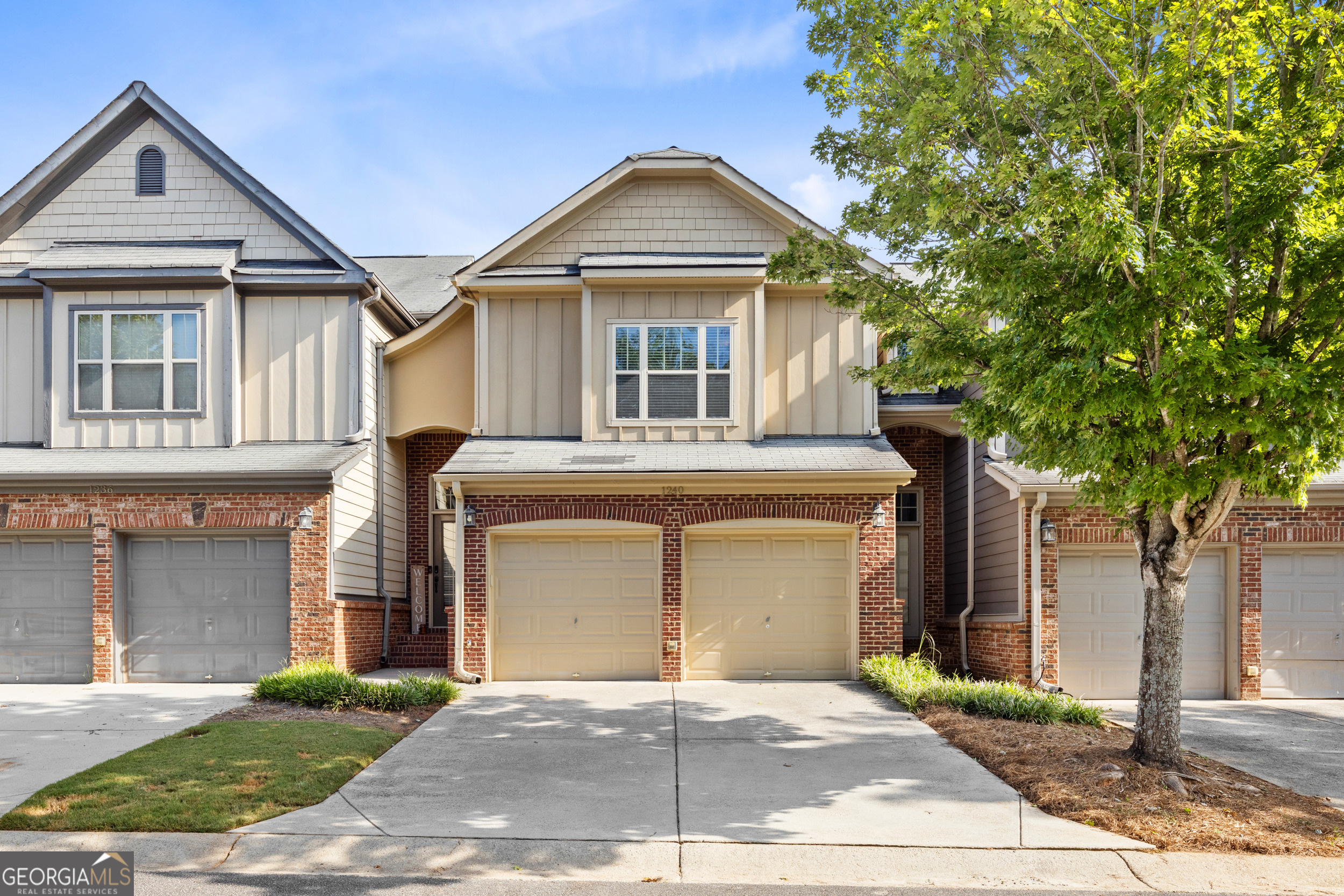 Welcome home to this charmingly designed townhome located in a gated community offering convenience, comfort, and style. With a private driveway and a two-car garage featuring separate doors, the exterior immediately impresses with cedar shaker, board and batten, and brick accents paired with a welcoming front stoop. Step inside to a two-story foyer where arched entryways lead to an open-concept dining and family room anchored by a cozy fireplace. Adjoining kitchen is complete with a breakfast bar, pantry, and stainless steel appliances. Direct access to the private patio from the heart of the home, perfect for entertaining or relaxing outdoors. Upstairs, you'll find three generously sized bedrooms, including a primary suite with tray ceilings, double vanity, garden tub, walk-in shower, and a large walk-in closet. Two secondary bedrooms share an additional full bathroom, offering plenty of space for family or guests. Enjoy outdoor living on the patio, which includes a privacy partition and a convenient storage room for tools, equipment, or seasonal decor. The HOA provides exterior maintenance and trash service, ensuring low-maintenance living at its best. Community amenities also include a pool and gazebo. Ideally situated near Kennesaw Mountain National Battlefield Park, City Club of Marietta, The Battery, and minutes from downtown Marietta, this home also offers quick access to major highways, healthcare, reputable schools, shopping, dining, and year-round entertainment.
