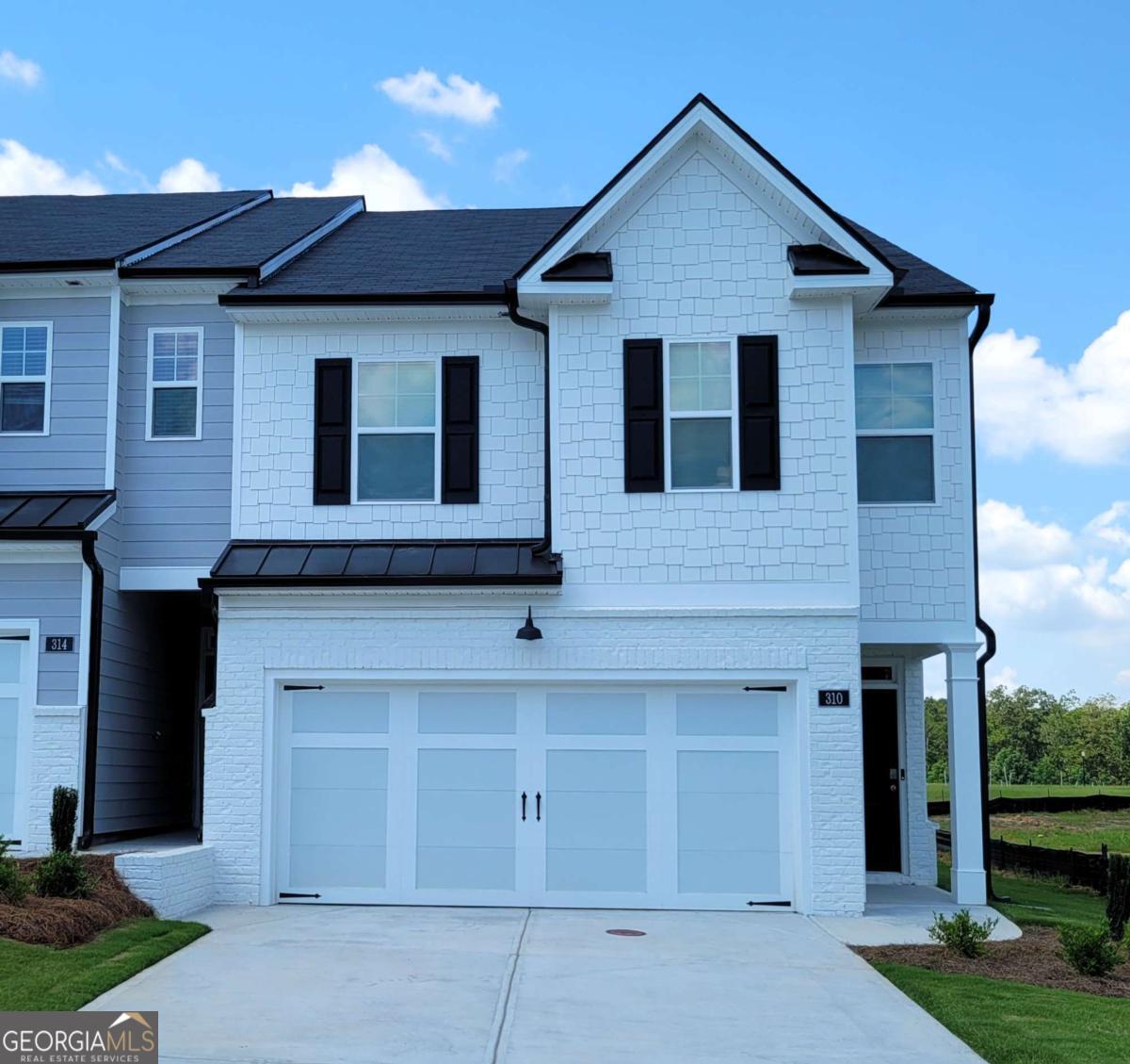Be the First to Call This Brand-New End-Unit Townhome Yours! Welcome to 310 Sound Circle in the beautiful new Echo Glen subdivision in Stockbridge-where style meets convenience in this brand-new, never-lived-in 3-bedroom, 2.5-bath end-unit townhome with 1,866 square feet of thoughtfully designed living space. Perfectly positioned just 4 miles from I-75 at Eagles Landing Parkway, this home offers the ideal mix of modern comfort, privacy, and low-maintenance living. Step inside and enjoy the fresh, open-concept main level featuring laminate floors and high ceilings that enhance the spacious, airy feel. The kitchen takes center stage with sleek quartz countertops, stainless steel appliances, and modern cabinetry-ideal for everything from casual weekday dinners to weekend entertaining. The end-unit location means privacy, extra windows, and abundant natural light, creating a bright, welcoming atmosphere throughout. Upstairs, retreat to the spacious primary suite featuring dual vanities, an oversized shower, and a large walk-in closet. Two additional bedrooms and a second full bath provide plenty of room for family, guests, or a home office. Generous storage throughout keeps everything organized. A spacious 2-car garage and extra-long driveway offer ample parking and storage options-perfect for multiple vehicles or guests. Plus, there are plenty of convenient visitor parking spaces nearby. Your private entryway opens to a landscaped setting-yard maintenance is included, so you can enjoy the beauty without the upkeep. As a resident of Echo Glen, you'll also have access to a neighborhood playground, dog park, scenic walking trail, and a gazebo with picnic facilities-perfect for weekend gatherings, morning strolls, or unwinding outdoors. This unit includes a personal smart home system, giving you app-based control of the doorbell camera, entry door access, lighting, thermostats, the garage door, security, and more-whether you're at home or away. Live minutes from Panola Mountain State Park, Reeves Creek Trail, and the Stockbridge Amphitheatre. Shopping, dining, and everyday essentials are just around the corner at Eagles Landing and the new Bridges at Jodeco-home to Costco, Starbucks, Sprouts, Chick-fil-A, Chipotle, Five Guys, and more. Piedmont Henry Hospital is also nearby for added peace of mind. Move into a space where everything is fresh, modern, and ready for you-be the very first to make this end-unit townhome your own. Basic qualifications include monthly income of at least 3X the rent, a minimum credit score of 620 (580+ with additional deposit), excellent rental history, verifiable income, and steady employment. No smoking of any kind is allowed anywhere on the property. Application fee is $65 per occupant 18 years and older. A flat monthly fee of $400 is required for electricity and water. Professionally managed for your peace of mind, this home blends location, lifestyle, and low-maintenance living into one exceptional rental opportunity. Available for move-in on October 1st. Note - GPS may not lead you directly to the home - use "Echo Glen by D.R. Horton" in GPS for directions to the subdivision.