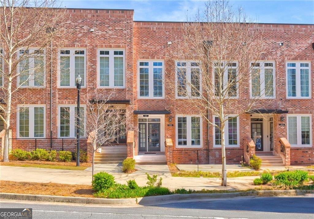 Experience the perfect blend of modern elegance and urban convenience in this stunning condominium at The Maxwell, Alpharetta's premier walkable community. Designed for effortless luxury, this residence boasts a bright, open-concept layout with soaring 10-foot ceilings, sleek new vinyl plank flooring, and designer lighting. Floor-to-ceiling windows flood the space with natural light, creating an inviting atmosphere. The gourmet kitchen is a chef's dream, featuring crisp white shaker cabinetry with soft close doors, an oversized quartz island, premium stainless steel appliances and ample storage. Overlooking the spacious living and dining areas, this seamless design extends to a spacious private covered balcony-ideal for enjoying morning coffee or evening cocktails. The primary suite is a tranquil retreat, offering a spa-like bathroom with marble floors, Quartz vanity with undermount sink, an oversized walk-in shower, and a custom walk-in closet. A separate den provides valuable flexibility-perfect as a home office, guest space, or even a second bedroom. A stylish half-bath and a dedicated laundry space complete the main level. This unit also includes a private one-car garage with an additional driveway space. Situated just steps from The Maxwell's top-tier amenities-including a pool and cabana, bocce ball, fire pits, and grilling stations-this home offers an unparalleled lifestyle. Enjoy direct access to the Alpha Loop, a pocket park, and the best of Downtown Alpharetta, including Fairway Social, award-winning dining, and boutique shopping. With Avalon, Wills Park and GA 400 just a mile away, this is the ultimate opportunity to own in one of Alpharetta's most coveted communities!