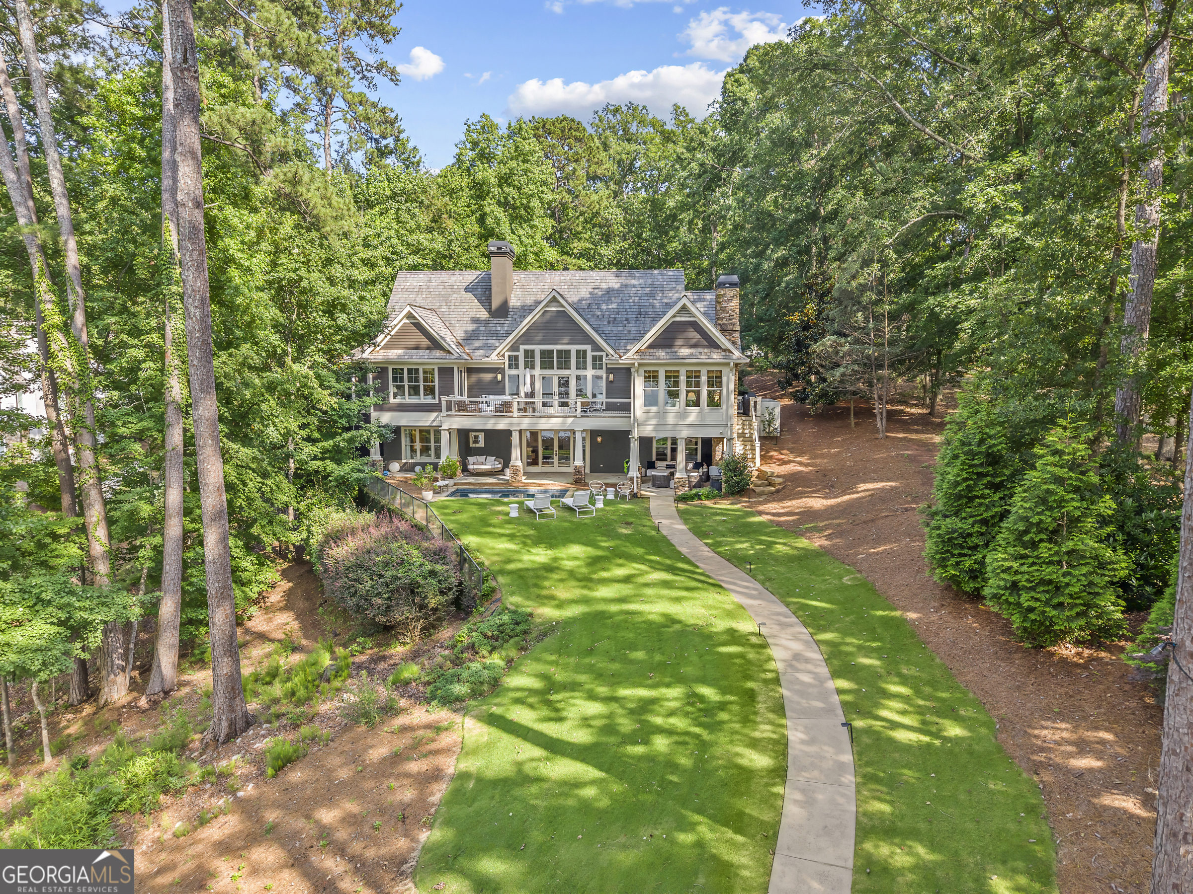 Experience the ultimate lakefront living with this stunning luxury home, perfectly positioned to offer breathtaking sunset views. Nestled in the serene landscape of Reynolds Lake Oconee, this remarkable residence boasts an open floor plan that seamlessly blends elegance and comfort, providing an ideal retreat for relaxation and entertaining. Recently renovated, this home exudes character and charm. The expansive gourmet kitchen, designed for the culinary enthusiast, opens directly into the spacious living and great rooms, allowing for effortless entertaining while overlooking the tranquil waters of the lake. Retreat to the oversized master suite on the main level, featuring dual sinks, a luxurious garden tub, and a walk-in shower, complemented by ample closet space for all your storage needs. Host friends and family in the beautifully appointed lower level, which includes three additional guest bedrooms, a stylish wet bar, and a brand new sauna-perfect for unwinding after a day on the water. Embrace the joys of lakeside living with a stunning pool and a covered deck, ideal for savoring afternoon cocktails while soaking in the vibrant sunset views. The home is equipped with a max dock and offers 16 feet of water depth, making it a haven for boating and fishing enthusiasts. Additional features include a spacious three-car garage with a large unfinished space, providing the potential for an additional guest suite or personalized expansion. This luxurious lakefront home is a rare find-offering privacy, style, and an unparalleled lifestyle in one of Georgia's most sought-after communities. Don't miss your chance to own this exquisite property- sellers are making golf membership available and this home is being sold FULLY FURNISHED. Schedule your private showing today!