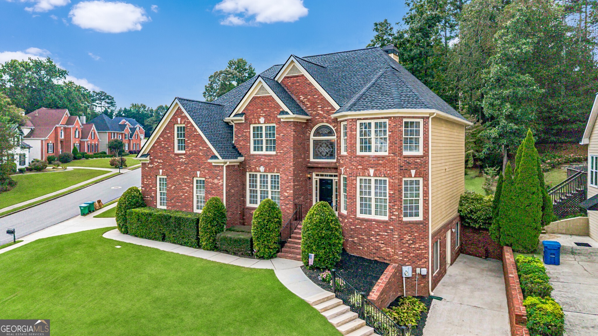 This elegant home in Parkview High is what you have been waiting for. It is massive; every room is large. The sellers have prepared it for sale with fresh paint inside and outside, beautiful new carpet, and brand-new appliances in the kitchen. Gleaming hardwood floors are found in the halls, foyer, stairs, great room, breakfast room, and kitchen. Walking into the two-story foyer, you will love all the light from the leaded glass windows. A formal living room, office, or music room is to the right, and a formal dining room that seats 12 is to the left. On the main floor is a large guest suite with a full bath that can fit a king-size bed. The great room has a fireplace with gas logs, built-in bookshelves, and room for one of those extra-large sectionals. The kitchen is a cook's dream with tons of freshly painted cabinets, new quartz countertops, a new backsplash, and brand-new appliances. The appliances include stainless steel double convection/air-fry ovens, a microwave, a 5-burner gas cooktop, and a dishwasher. Upstairs are 4 bedrooms and 3 full baths, including the primary. The primary suite stretches from the front to the back of the house. It has a large bedroom that will fit any suite of furniture, a spacious sitting room that could hold an entire family room suite, a separate exercise room, and a walk-in closet. The primary bath has updated tile on the floors and in the shower, double vanities, a vaulted ceiling, and a jacuzzi tub. The shower features a seat and a frameless glass door. The laundry room has a sink, built-in cabinets, hanging racks, and the washer and dryer remain. The privacy-fenced backyard is level with a lovely patio surrounded by a low brick wall, and there is beautiful landscaping. The two-car side-entry garage has a freshly painted floor. The basement is unfinished and stubbed for a bath. There is a workshop sink in the basement and a second driveway that makes bringing tools or supplies to the basement a breeze. You will love this house!