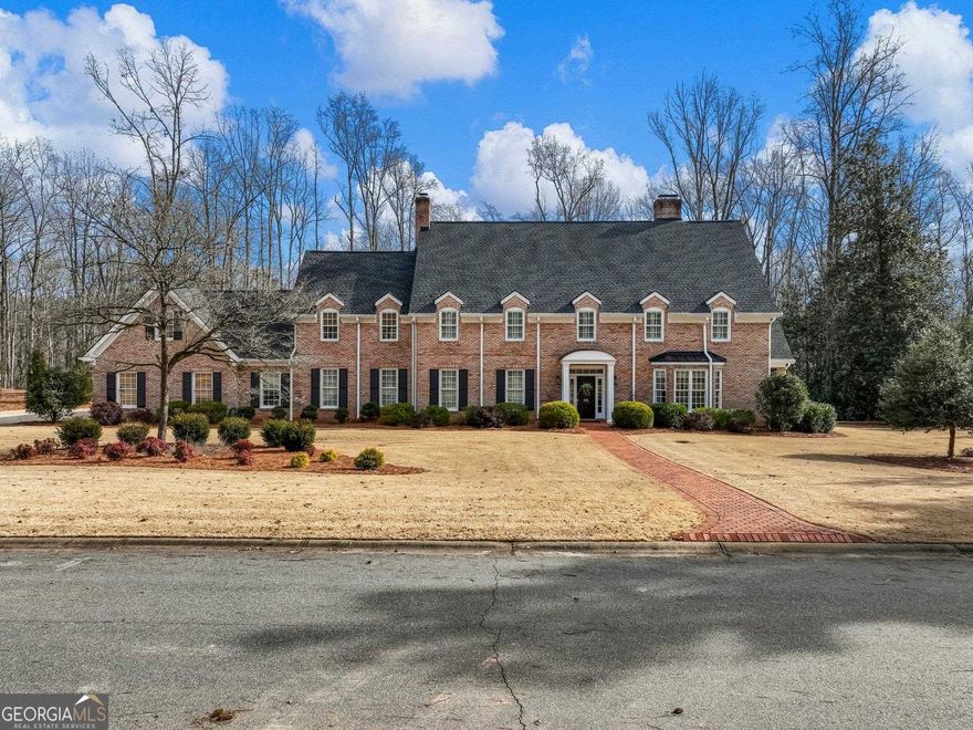 The epitome of the Classic Southern Home meeting Modern Sophistication is found in this Elegant, All Brick Estate nestled on 2 private acres in West Athen's - Sedgefield. Highly spacious, yet intimate & cozy, this floor plan will appeal to buyers loving a defined room plan, as well as an open concept plan w/ it's easy flow & large spaces. Upon entrance, you will be "Wowed," but, focus back on the grand 2-story open staircase & rich hdwd flrs found throughout the entire home. To the right find the Great Rm boasting wood burning fplc, 4 bowed front windows, & gorgeous, custom wall of windows interspersed w/ a bookshelf between each window. All windows in home offer custom plantation shutters & many, decorator roman shades. To the left is the formal (or casual) Dining Room w/ double doors leading into the Kitchen & Family Room. Take a breath as you make your way into the finely appointed & true Heart of the Home.  This state-of-the-art Kitchen hosts Spagnol Cabinetry, timeless absolute black leather finish granite, Top of the line stainless appliances (including Dacor drawer microwave, Double convection ovens, 5 burner gas cook top, Miele Dishwasher & French door refrigerator), oversized prep & gathering island, coffee bar, ample counter space, built in pantries, spice closets & stainless farm sink. The kitchen extends into the breakfast area featuring a built-in window seat, wet bar & brick wall giving the room add'l southern character & warmth. From the Kitch or Dining Rm, enter the generous sized Family Rm w/ big brick hearth & Fplc featuring a wood storage cabinet. Wall of sliders will fully open to bring outside entertaining into this room! From the family room is access to the scrn'd porch, the fun study/pet/play nook under the stairs, the back stairway, & the 3-car garage. Off the foyer hallway are multiple storage closets & well-appointed powder room. On the right wing past the Laundry Rm is the Lavish Owners Suite boasting space for large furniture & sitting area around the fplc. The Suite opens to its own patio area overlooking the pool. Vestibule to Ensuite offers His & Hers closets which gives the opportunity for more privacy w/out the bath door right in bedroom! Absolute luxury abounds in renovated bath w/ freestanding soaking tub, separate shower w/ frameless glass, double sinks, & beautiful quartz countertops. Making your way up the graceful, open staircase, take in the extensive trim & the fine appointments, as they a will again set the stage for what is to come upstairs! At the top of the staircase is the entrance to the rear balcony viewing the magnificent property. What a great place for stargazing in the big open Athens sky!  Hdwd flrs & quality amenities found on main level continue upstairs & in all bedrooms. There are four 4 bdrms upstairs, each with their own charm. Two share a spa-like jack & jill bathroom and the other two share a very large hall bath.  The 4th bedroom opens to a bonus room w/ back stairs to main level...perfect for teen or au pair.  Moving outside, is your private retreat on 2 acres...most of the property has been professionally landscaped except the private woods you view & share with the deer family neighbors. Enjoy the heated pool, and definitely bring all your furry friends, because a large portion of the yard is fully & tastefully fenced.  Prestigious Sedgefield is one of West Athens best kept secrets.  Tucked away off Tallassee, it is just minutes to the Loop, UGA Medical College, Prince Ave Medical Center & Piedmont Athens Regional Hospital, Downtown, & UGA. Enjoy Intown living but have the advantage of acreage & insulation from traffic... immerse yourself when you want! They are no longer building a true Classic Home like this today in the Classic City! However, with this beautiful estate you also have: NEW roof, windows, kitchen, baths, HVACs, and hot water heaters all new or under 5 years, flooring, paint, all pool equipment, landscaping & more! Welcome Home.