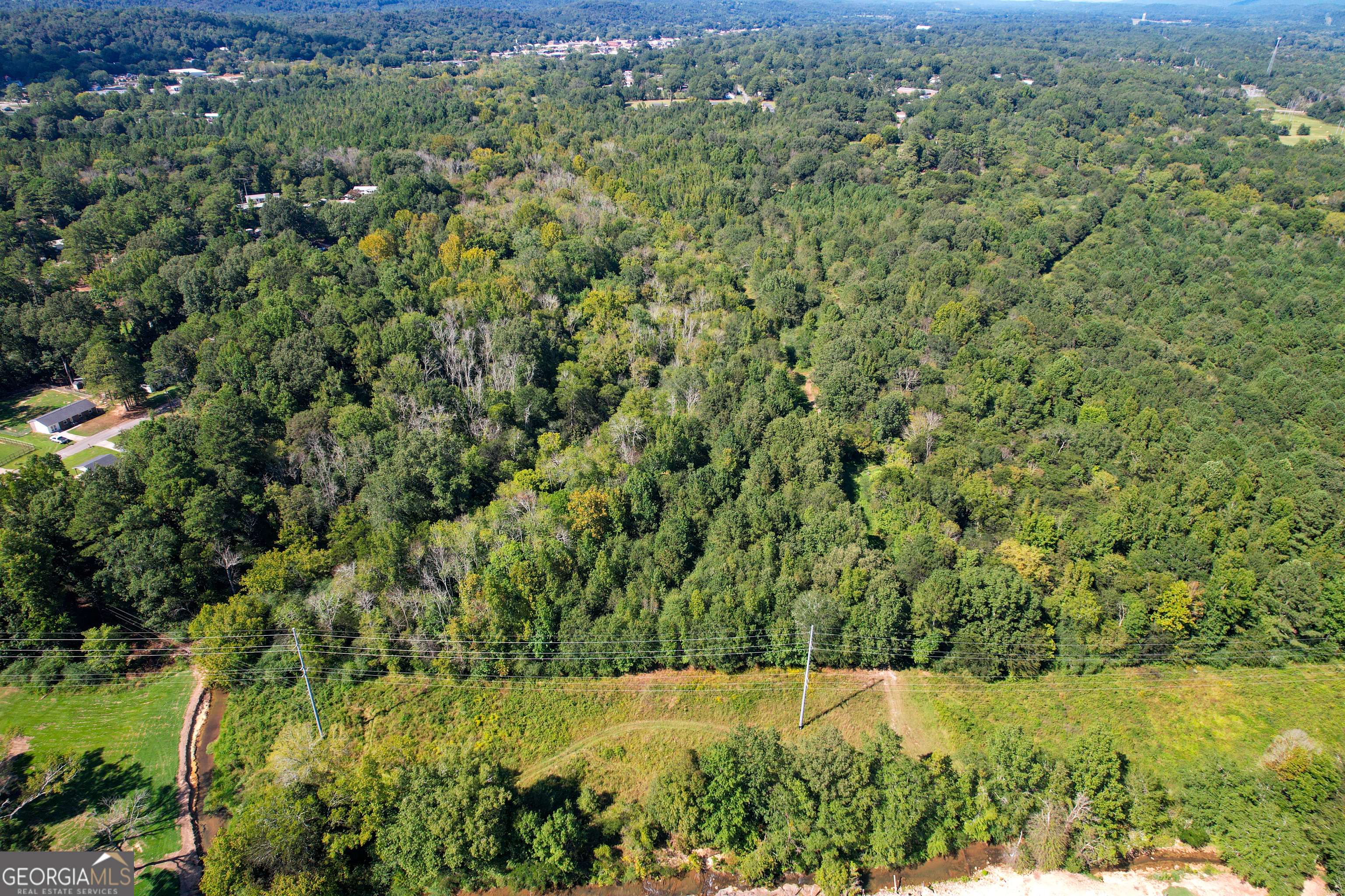 Welcome to an incredible opportunity to build your very own private home in a convenient location near Summerville, GA. This property is perfectly situated to provide easy access to all the amenities the area has to offer, while still maintaining a private and peaceful atmosphere. Ease your construction process with available utilities, including sewer, to bring your dream home to life seamlessly. Immerse yourself in the natural beauty of the property, with a mix of natural hardwood trees and pine trees, creating a picturesque backdrop for your future home. Enter through the gated entrance, ensuring privacy and security. This property offers more than just a homesite; it also provides exciting opportunities for recreational activities for the whole family. Enjoy the thrill of hunting with abundant wildlife or soak in the joy of camping and outdoor recreation right in your own backyard. Explore the trail system that meanders throughout the property, offering picturesque pathways for exploration and adventure. The flat topography of the land makes it ideal for various uses, providing versatility and potential. With frontage on Town Branch, a year-round flowing creek, you can delight in the soothing sounds of water as it enhances the natural beauty of the surroundings. Some areas of the property along the creek are in the floodplain, this feature also adds to the natural allure and charm of the land. It also creates flooded timber for waterfowl in the fall and winter. Don't miss this opportunity to create the perfect haven tailored to your preferences and desires. Embrace the beauty of nature, exciting recreational possibilities, and the convenience of this great location.