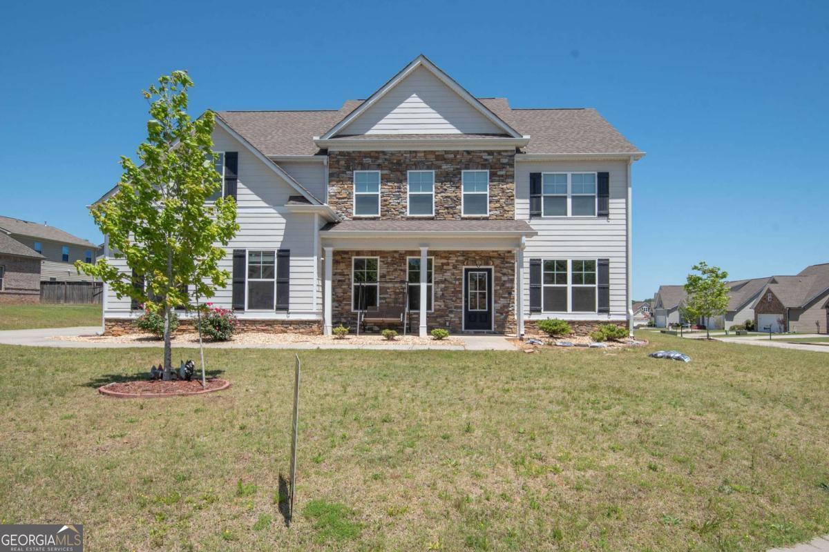 Are you looking for space? Come check out this open concept home with 5 spacious bedrooms, 3 full baths, and two large family rooms. Hardwood flooring in foyer, main level family room, kitchen, sitting room, hall, and dining room. Kitchen has granite countertops, breakfast area, and stainless steel appliances. Popular floor plan with guest suite and full bath on main level. The expansive master suite has double vanities, garden tub, separate shower, and 2 walk-in closets. Private rear patio off breakfast area. Neighborhood amenities include pool, tennis courts, clubhouse, and access to private community lake. Call or text for additional details or your private showing. 678-378-7519