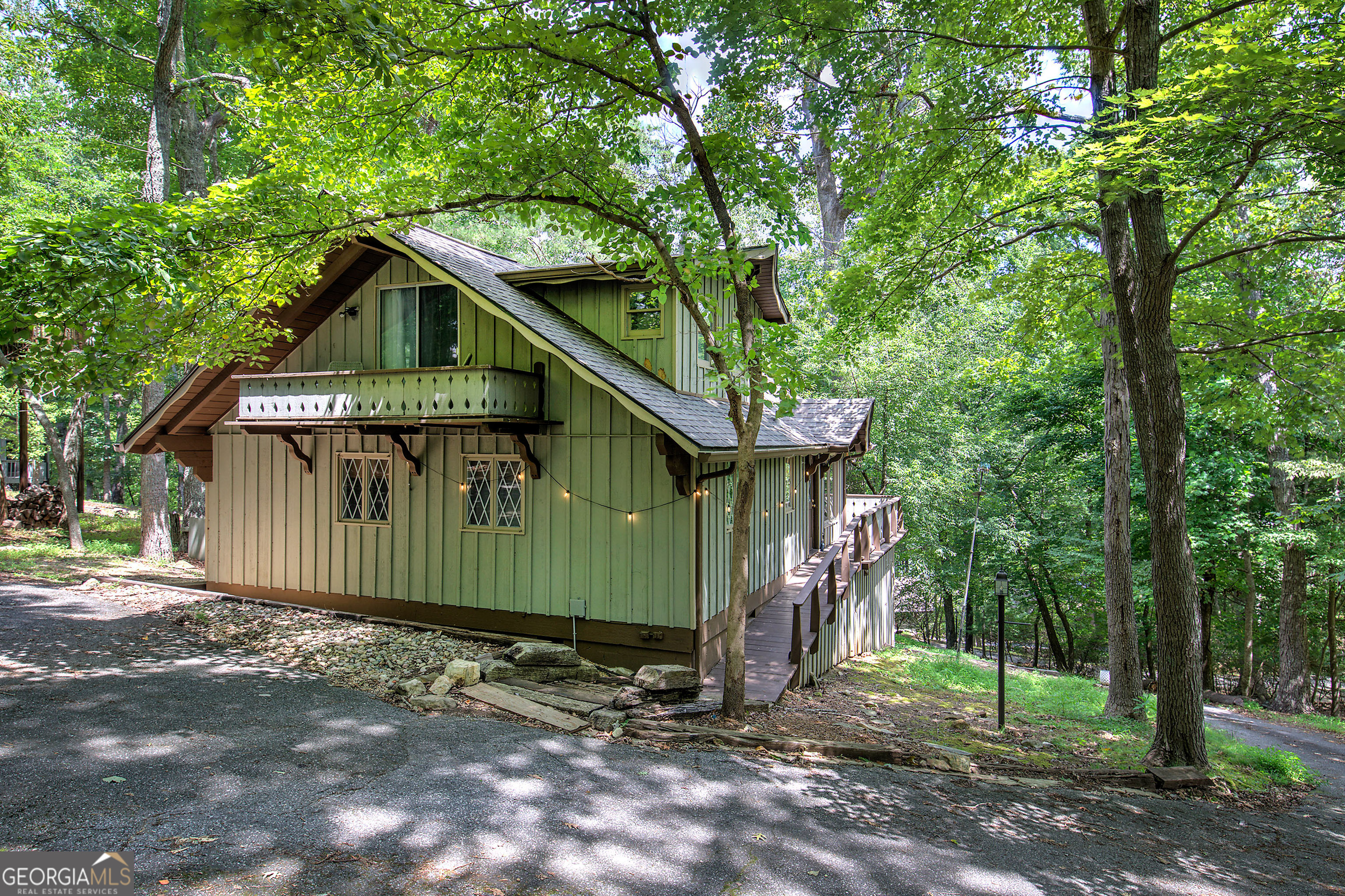 Charming Mountain Cottage in Sought-After Bent Tree Community! Welcome to this delightful mountain retreat nestled in the desirable Bent Tree Community of North Georgia. Brimming with character, this beautifully updated home features brand-new appliances and fresh white-washed interior paint, creating a bright and airy ambiance throughout. Step inside to discover the perfect blend of rustic charm and modern comfort. A stunning natural stone fireplace anchors the living space, complemented by warm earth tones and soft textures that invite relaxation. Whether you're searching for a weekend getaway or a cozy full-time residence, this mountain gem is move-in ready. Enjoy peaceful mornings on the deck, breathe in the crisp mountain air, and soak in the serene beauty of the natural surroundings.