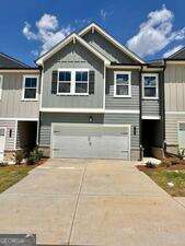 Welcome to Logan Point! Our newer townhome community in Loganville offers a peaceful lifestyle. The open floorplan boasts a modern layout with a spacious kitchen with an island overlooking the family room featuring a fireplace. Enjoy painted white cabinets, granite countertops, and a full tile backsplash in the kitchen. Luxury vinyl plank flooring is found throughout the main level, bathrooms, and laundry areas. The large primary suite includes a walk-in closet and private bathroom with a spacious walk-in shower and linen closet. Upstairs, you'll find an oversized laundry room, loft, and bedrooms with easy access.