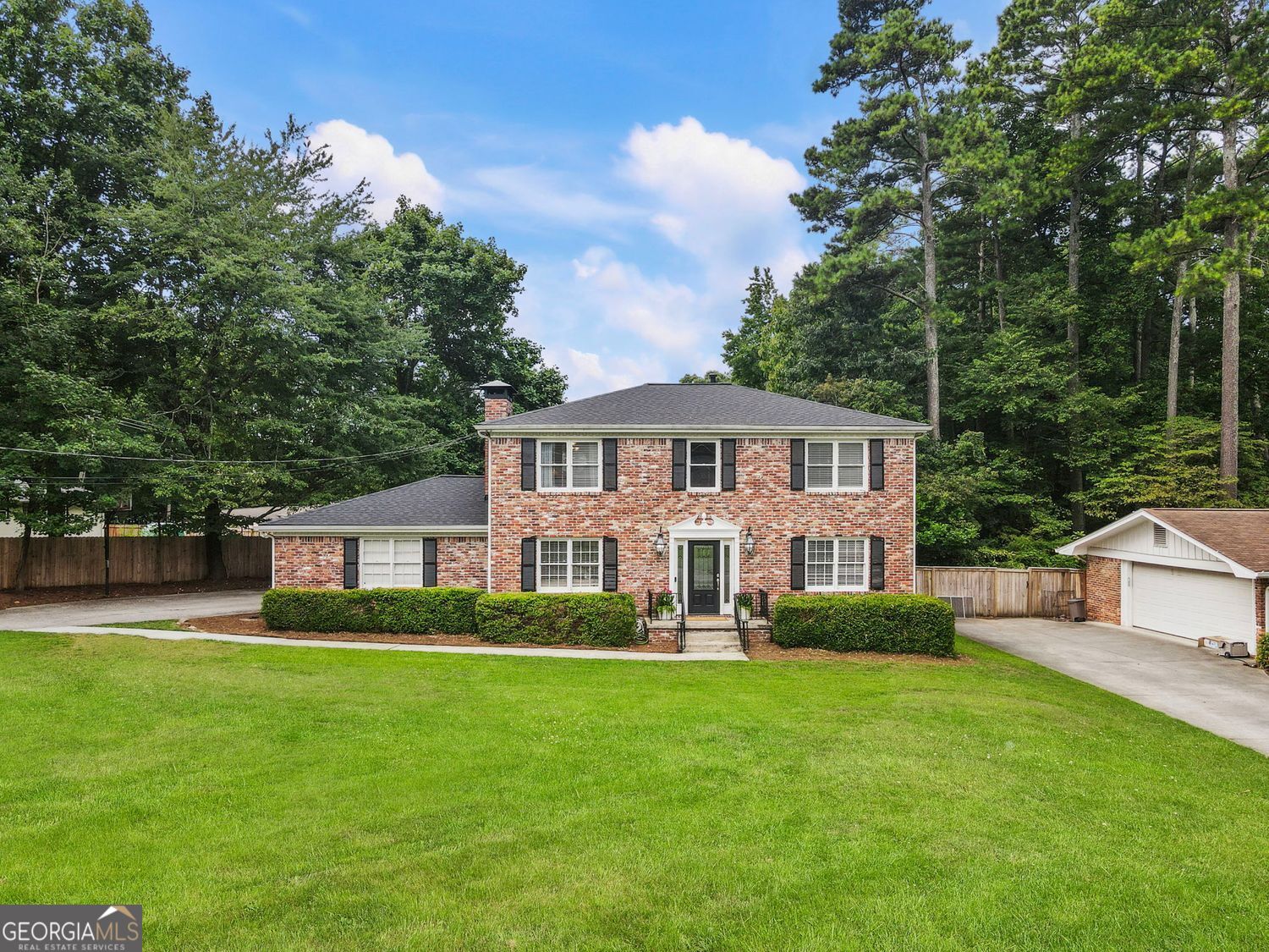 Fall in love with this beautiful 4-sided brick home in the heart of highly desirable Dunwoody-just a short walk to Brook Run Park! Step inside to a light-filled two-story foyer that sets the tone for this inviting home. Located in the Dunwoody High School district, this move in ready home features warm hardwood floors and has been lovingly maintained. The bright and updated kitchen with granite countertops and stainless steel appliances is ideal for home-cooked meals and weekend brunches. Enjoy the breakfast room that opens to the patio through sliding glass doors. The cozy family room, complete with a charming fireplace, is the perfect spot to relax. For entertaining and family gatherings, take advantage of the additional living and dining room. Have peace of mind with a brand-new roof and a recently upgraded water heater. Upstairs, you'll find the spacious owner's suite with an ensuite bath and three additional generously sized bedrooms and another full bath. The flexible layout makes work-from-home or guest space a breeze. Step outside to your large and private fenced backyard with the covered pergola-perfect for unwinding. With its unbeatable location near the vibrant Dunwoody community, this home is the perfect mix of suburban feel with in-town convenience. Located near lush parks, trails and endless shopping and dining. Enjoy weekend walks at Brook Run Park, grab coffee at a local cafe, or get on I-285 / 400 for an easy commute. Don't miss your chance to call this sweet Dunwoody gem home!