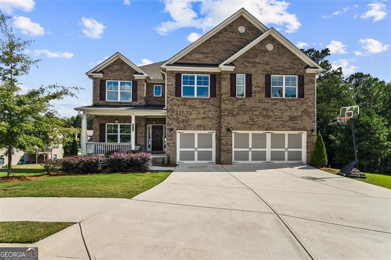Welcome home to luxury living at its finest! This stunning 6-bedroom, 5-bath residence at 3345 Spring Place Court in desirable Loganville offers elegance, comfort, and exceptional attention to detail. Situated on a beautifully landscaped lot in a tranquil cul-de-sac with a view of Ozora Lake this home boasts generous living spaces designed for both entertaining and relaxation. Step inside to discover an impressive two-story foyer, gorgeous hardwood floors, and abundant natural light throughout. The open-concept chef's kitchen features premium appliances, granite countertops, custom cabinetry, and an expansive center island, seamlessly flowing into a spacious family room with a cozy fireplace. The luxurious primary suite upstairs is a private retreat, offering a spacious sitting area, walk-in closet, and spa-like bath complete with dual vanities, a soaking tub, and a separate shower. Each additional bedroom is generously sized, offering flexibility for guests, home offices, or a growing family. A conveniently located guest suite on the main level adds to this home's thoughtful design. Entertain effortlessly in the fully finished basement, perfect for game nights, a home theater, or a gym. Outside, enjoy the expansive deck overlooking a private backyard, ideal for gatherings, barbecues, or peaceful evenings. This beautiful Loganville home offers easy access to excellent schools, shopping, dining, and parks. Don't miss your opportunity to call this extraordinary property home! Open House Sunday, 8/3, 2:00-5:00 pm