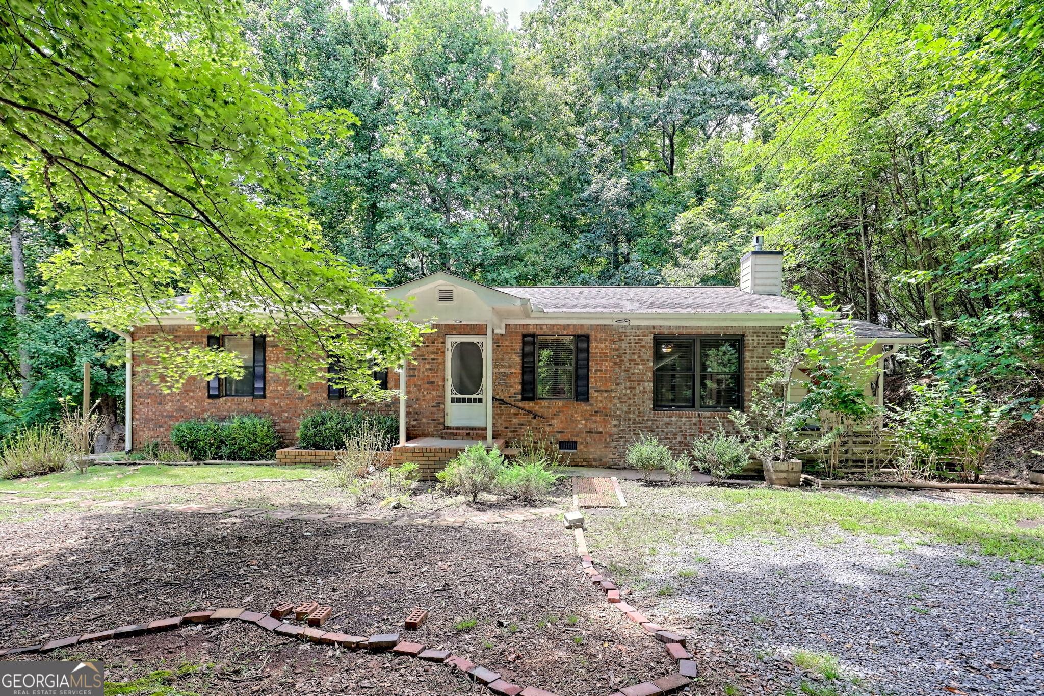 Charming older single-level 2 bedroom/1.5 bath brick home. Carport has been closed in for family room with gas-log fireplace and additional bonus room (third bedroom/office) added in 2015. New roof in 2016, new HVAC in 05/24. Wood flooring throughout. Nice yard with high chain link fenced back yard. Three bedroom septic permit. Firepit area, raised garden bed, and end of the road privacy. Close to town and lake. Additional buildable lot included. No restrictions. Great rental potential.