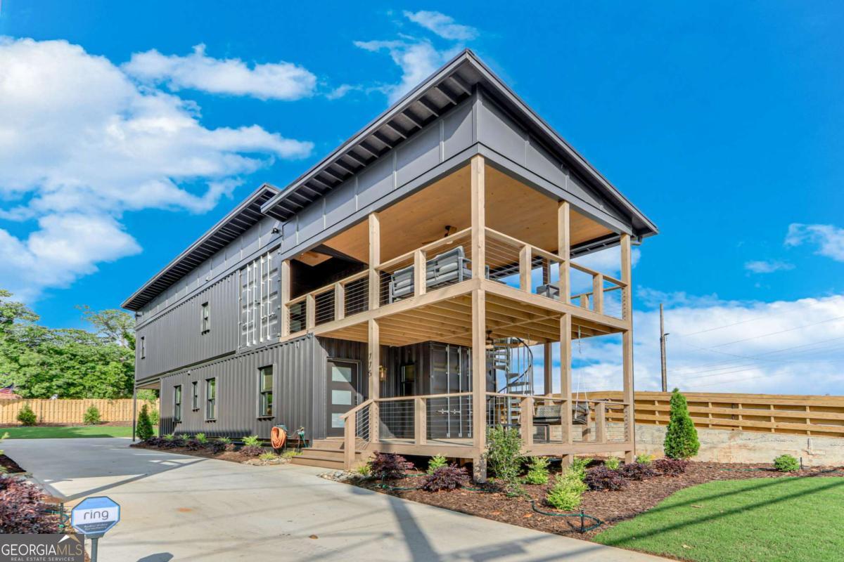 Modern. Bold. Completely one-of-a-kindCoright in the heart of Midtown Gainesville. Step into this brand-new, fully furnished container home and experience a rental like no other. With 2 bedrooms, 2.5 bathrooms, top-of-the-line appliances, stylish furnishings, and all utilities included, this home is move-in ready with zero hassle. The open layout flows effortlessly to the main level deckCoperfect for morning coffee or grilling out. Upstairs, the primary suite offers a private deck for winding down in peace, plus a third deck gives you even more room to relax or entertain. Just steps from local breweries, restaurants, parks, and everything Midtown has to offer. No hidden fees. Just smart design, great location, and seriously good vibes.