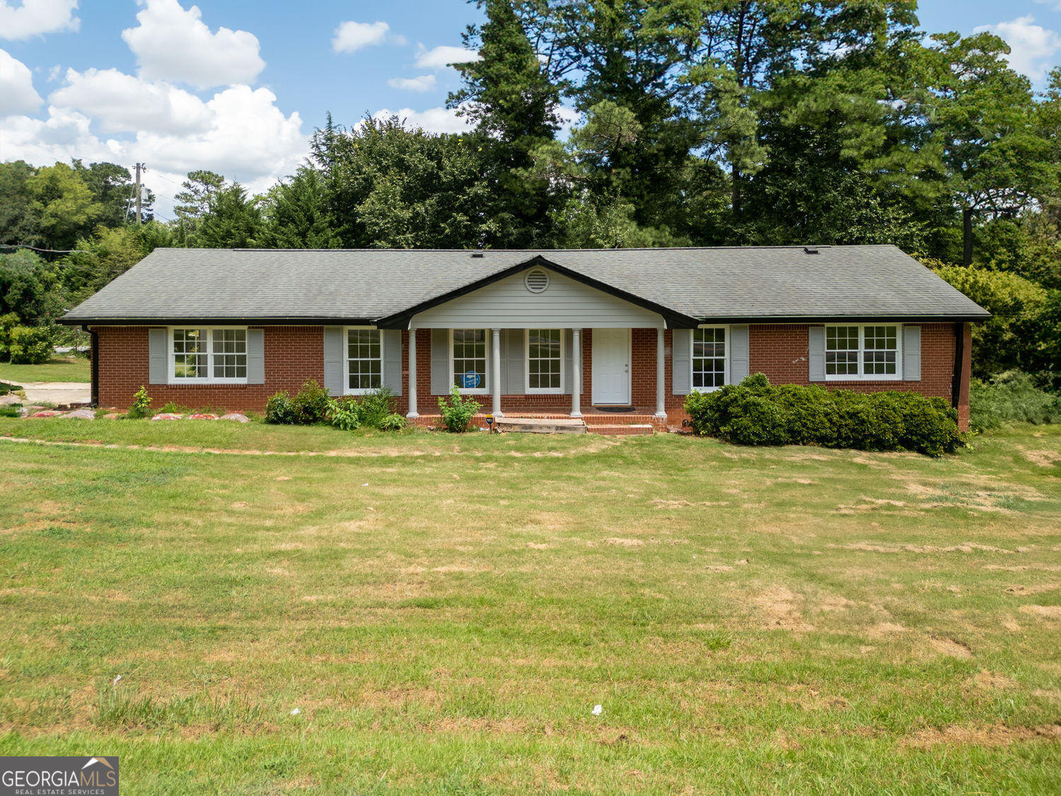 All-Brick Ranch in Marietta - Prime Location Near Schools and Shopping! Welcome to this charming four-sided brick ranch, perfectly situated in the heart of Marietta! This home sits on a spacious corner lot and features a fenced backyard with mature trees-and even your very own fig tree! Inside, enjoy a bright floor plan with updated flooring, stainless steel appliances, and a cozy living room with a whitewashed brick fireplace. Step out onto the covered back patio and enjoy peaceful mornings or relaxed evenings in your private yard. Whether you're looking for a primary residence, a long-term rental, or an Airbnb opportunity, this home offers excellent potential as an income property. Close proximity to The Battery at Truist Park, you'll love being close to Braves games, restaurants, shopping, and easy highway access.