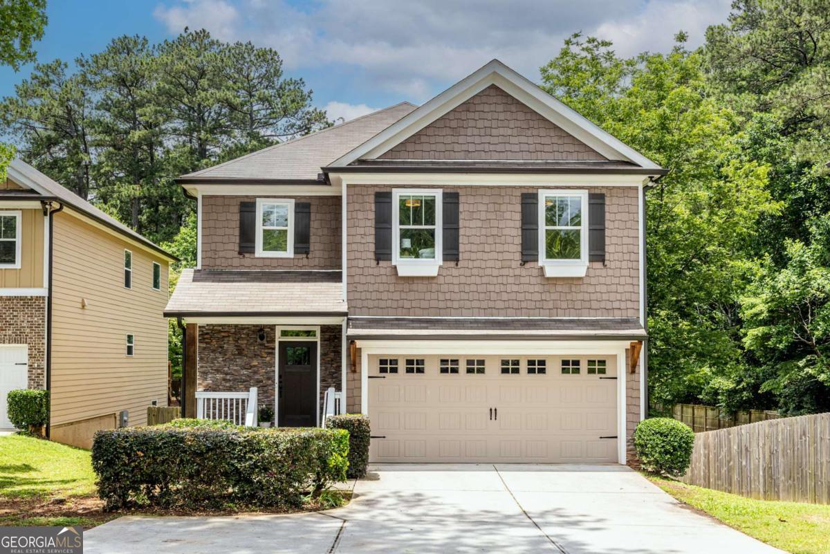 Welcome to your dream home in Tucker! Built in 2019 and freshly painted inside, this 4-bedroom, 3.5-bathroom gem offers modern living just 1.5 miles from the heart of downtown Tucker-known for its charming Main Street, local shops, and cozy restaurants. With easy access to I-285 and the Stone Mountain Freeway, you're just 15 minutes from downtown Decatur and conveniently connected to all that metro Atlanta has to offer. Inside, you'll love the real hardwood floors, open concept layout, and generous natural light throughout. The oversized primary suite features a spacious bathroom with double vanities, soaking tub, separate shower, and a huge walk-in closet. Upstairs also includes a large laundry room and three secondary bedrooms-one with its own ensuite and walk-in closet, and two bedrooms that share a hall bath. Step outside to enjoy coffee or quiet evenings on the back deck overlooking a flat, fully fenced yard with serene wooded views and visits from songbirds, owls, and hawks. The large, unfinished walkout basement with daylight windows is stubbed for a bathroom and ready for your personal touch-think media room, gym, or in-law suite! Located within walking distance to Idlewood Elementary School and the Drayton Woods Recreation Club (membership required), where you can enjoy a private pool, park, playground, and nature trails. Come experience the best of suburban living with small-town charm-this Tucker home truly has it all!