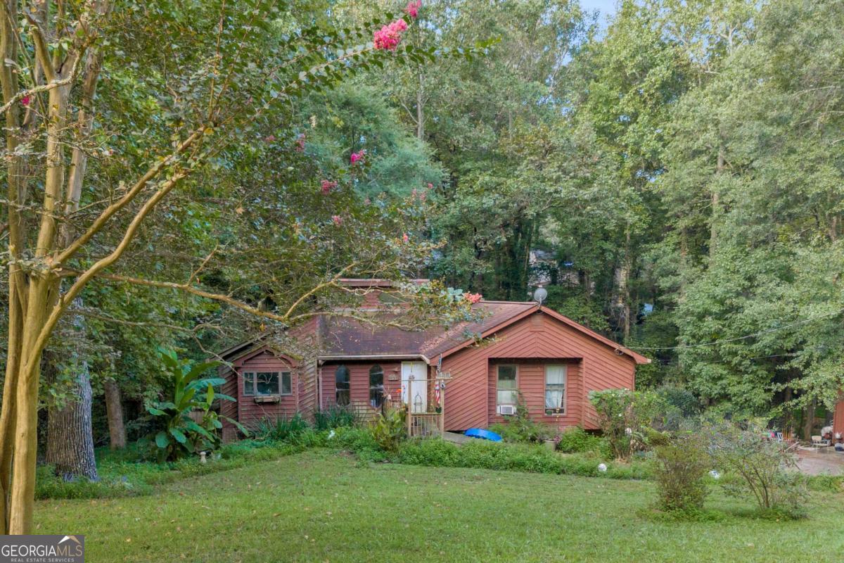 Investor Special - 4BR/3BA on Nearly 1 Acre in Gwinnett County! Cash buyers only! This 4-bedroom, 3-bath home sits on TWO LOTS - totaling 0.92 acres - in a sought after area of Gwinnett County in the Brookwood High School District. With a master on the main and a finished basement, there's incredible potential to transform this property into a stunning primary residence, flip, or rental. This is an investor special - the home needs repairs and is priced accordingly. The spacious layout, large TWO lots, and finished basement offer great value for those ready to renovate. Call the listing agent for further details.