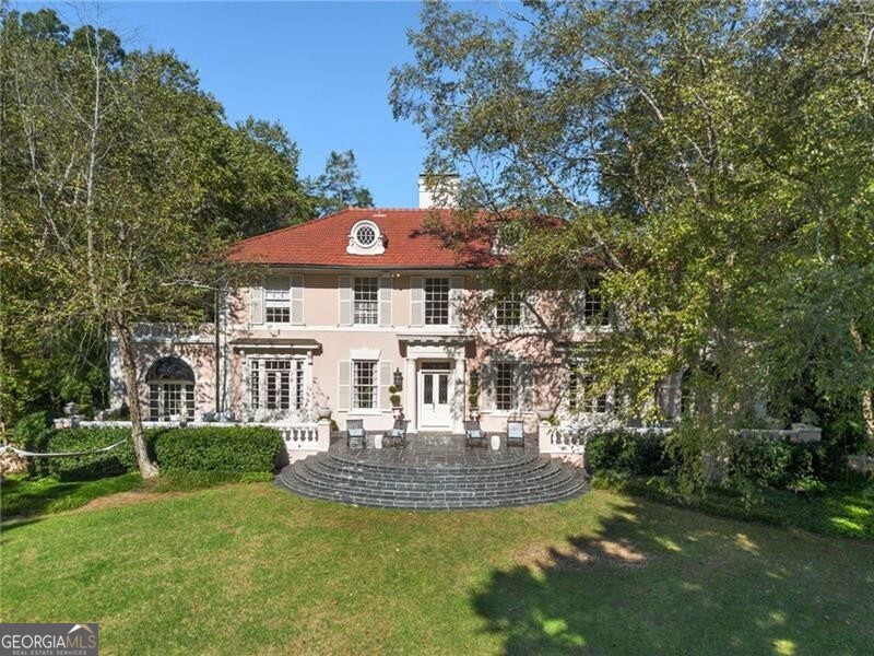 The stunning 1915's Austell Estate was thoughtfully designed by famed New York architects Carrere & Hastings. This remarkable Buckhead home sits on 2.88+/- acres of manicured grounds overlooking W Andrews and Austell Way. The tree lined driveway leads to a porte cochere with fountain and covered entry. The main level is truly grand with oversized living spaces, ideal of entertaining such as the formal living, study and parlor. There are also many options for outdoor entertaining, such as the sweeping porch off of the formal living room and the kitchen and keeping room opening to the pool and cabana. The house is filled with charm and history yet has been renovated for today's living. Upper level staircase leads to 3 bedrooms including spacious primary suite with separate sitting room. There are two secondary bedrooms on the upper level both with their own private baths. The grounds are truly so special and breathtaking with a large level meadow in the back of the house, large front yard, pool, cabana, carriage house with lower level and upper level and ample parking. Truly an entertainer's home on a coveted and revered street in Peachtree Heights West. The main house has 3 bedrooms and 4.5 bathrooms. The guest house has 2 bedrooms and 2 full bath.