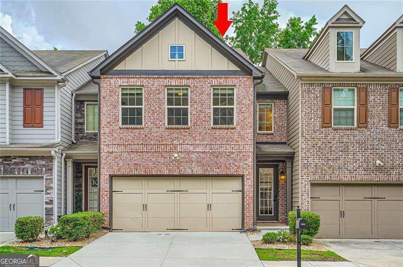 Welcome to this beautifully maintained townhome nestled in the quiet and highly desirable Watermark community. Thoughtfully designed across three spacious levels, this home offers 4 bedrooms, 3.5 bathrooms, and ample living space. Perfect for families, guests, or those who need a home office. As you step inside, you're greeted by a bright and open main level that effortlessly blends style and function. The living room features coffered ceilings, a built-in bookshelf, and a cozy fireplace-creating a warm and inviting space to unwind. The kitchen has a walk-in pantry, granite countertops, and stainless steel appliances (New refrigerator to be delivered) that flow into the dining area-ideal for both family dinners and special gatherings. Additionally, a deck off the main level provides a peaceful spot to enjoy your morning coffee. The upstairs opens up to an oversized loft -ideal for family gatherings or a relaxing retreat. The spacious primary suite features vaulted ceilings and large windows that flood the room with natural light. The primary bathroom includes a double vanity, a relaxing soaking tub, and a separate glass-enclosed shower. Two additional upstairs bedrooms share a well-appointed full bathroom, offering flexibility for family or guests. The fully finished basement expands the living space even further with a generous secondary living area, a 4th bedroom, and a full bathroom-ideal for an in-law suite, teen retreat, media room, or home gym. From here, walk out to a private patio that opens to the backyard which is perfect for relaxation, or entertaining guests. Situated in a prime location, this home offers convenient access to the Mall of Georgia and an array of shopping, dining, and entertainment venues. For outdoor lovers, Lake Lanier is just 15 miles away, offering endless opportunities for boating, fishing, and recreation. Commuters will appreciate the close proximity to I-85, I-985, and GA-400, all within minutes away. This home combines comfort, convenience, and lifestyle-all in one beautiful package. Don't miss the chance to make it yours!