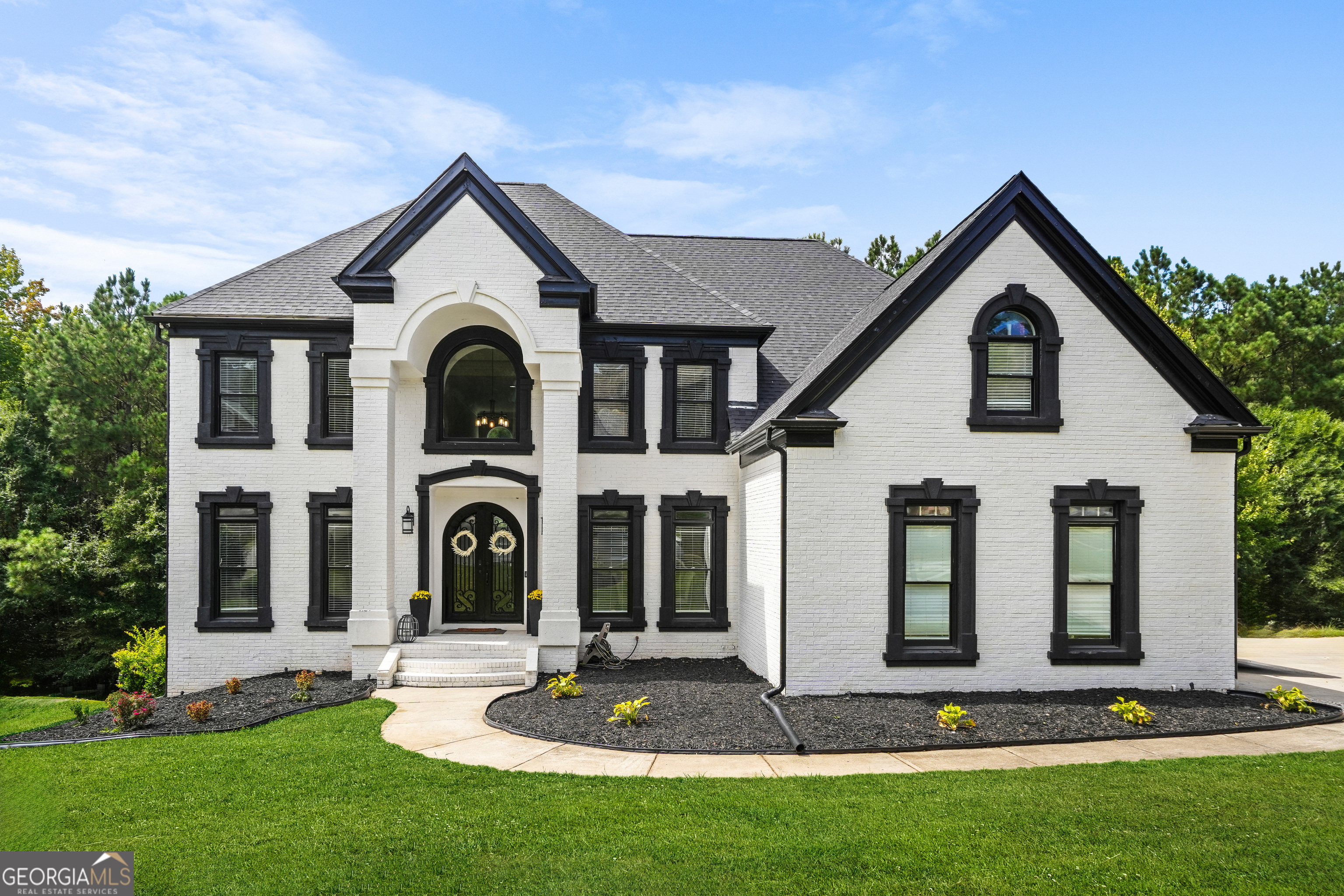 Experience an extraordinary standard of living at 4519 Mossey Drive, an elegant traditional single-family estate blending opulence, comfort, and boundless opportunity. This remarkable residence boasts seven spacious bedrooms and five beautifully appointed bathrooms, offering an unrivaled haven for both grand entertaining and intimate family moments. Step into a stunning foyer, where soaring high ceilings set the tone for the grandeur found throughout. The chef's kitchen is a culinary masterpiece, outfitted with double ovens and refined finishes, seamlessly connected to a dining area ideal for memorable gatherings. Entertain guests with ease in the formal living room or retreat to the oversized deck, capturing sweeping views and serene sunsets. The finished basement is designed for ultimate versatility, featuring a bar for sophisticated hosting, a home theater for immersive entertainment, and an exercise room that inspires wellness right at home. Amplify productivity in the dedicated home office, or unwind beside the outdoor fire pit, savoring peaceful evenings in a private setting.Every detail has been thoughtfully considered, including a laundry room and a two-car garage offering convenience with ample storage. The expansive layout effortlessly facilitates multi-generational living or the accommodation of guests, ensuring versatility without compromise. This residence is perfectly positioned for those seeking tranquility without sacrificing convenience. Located in a desirable community, this home offers easy proximity to top local amenities. Enjoy quick access to I-285, I-20, peaceful neighborhood parks and nearby dining options within minutes. Neighborhood schools, shops, and recreation are all conveniently close, making this property an ideal choice for those who value both privacy and community connection. This property stands as a rare offering for buyers seeking an incomparable lifestyle surrounded by natural beauty, luxury, and easy access to elite amenities. Immerse yourself in comfort, sophistication, and luxury. Schedule your private viewing today and step into your forever home.