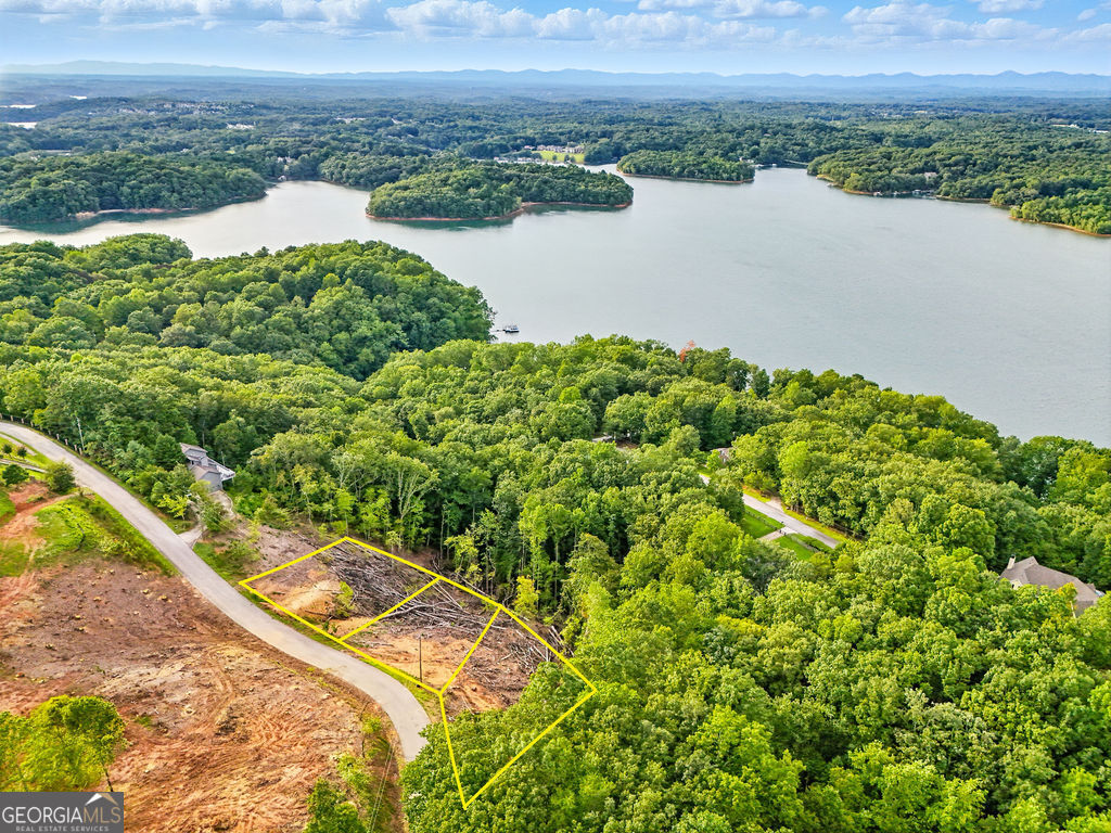 Stunning Lake Lanier Views! These 3 combined lots have been recently cleared and are ready for you to build your dream estate or up to three separate homes. Perched above the lake with breathtaking views of the water and surrounding mountains, this property offers a rare opportunity to own prime land in a highly desirable location. Whether you're envisioning one expansive private retreat or multiple residences, the possibilities are endless. Don't miss this chance to create your perfect escape overlooking beautiful Lake Lanier!