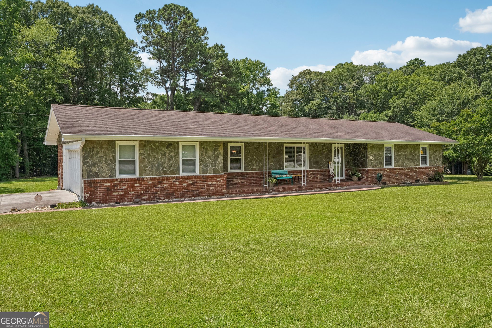 PRICE IMPROVEMENT....DON'T MISS OUT ON THIS GEM!!! CHARMING RANCH HOME "PLUS" ADD'L BUILDING LOT AND ADD'L 2 CAR GARAGE/WORKSHOP located in the Heart of Fayetteville. Welcome to this cozy brick and stone ranch that is brimming with Southern charm, lovingly maintained by its original owner and nestled on a beautifully level, approximately .72-acre lot in the City of Fayetteville. This warm and inviting 3-bedroom, 2-bath home offers timeless appeal and functional living in an unbeatable location. Step inside to find a spacious open-concept den and dining area, complemented by a separate family room that flows effortlessly into a delightful 308 sf. screened-in porch-perfect for morning coffee or relaxing evenings. The kitchen features a stainless-steel refrigerator, white dishwasher, and wall oven with easy access to a cozy porch ideal for grilling. The home is thoughtfully designed with a walk-in, handicap-accessible soaking tub in the hallway bath, providing comfort and convenience. Additional highlights include pull-down attic stairs with extra attic storage, a welcoming front porch perfect for sipping Georgia sweet tea, and a fully encapsulated crawl space by AquaGuard with a dehumidifier and smart pump system for peace of mind. The attached 2-car garage includes an additional storage room housing the water heater. PLUS a BIG perk...NO HOA! But the real bonus is a detached garage/workshop approximately 576 sf with room for two additional vehicles and two spacious rear rooms - offering endless possibilities for hobbies, projects, or storage. This property also includes a grandfathered-in, buildable approximately .42-acre Lot, expanding the total property size to 1.14 acres - an incredible opportunity for future growth or investment. The additional Lot address is 675 Beauregard Blvd. Tax Parcel # 052309044. Enjoy the convenience of being just 3 minutes to downtown Fayetteville, 5 minutes to Piedmont Fayette Hospital, 11 minutes to Trilith Studios, and only 16 minutes to Peachtree City. Surrounded by shopping, dining, and medical offices, this location simply can't be beat. Don't miss your chance to own this well loved gem - schedule your showing today! Homes like this don't last long!