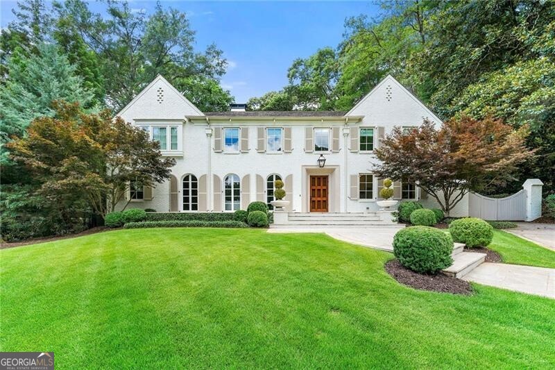 This beautifully rebuilt Haynes Manor home offers a classic exterior with a blend of contemporary interior details. Designed by Pak Heydt with no detail left untouched, this lovely home was also honored as an Atlanta Homes & Lifestyles Holiday Showhome in 2016. A quintessential rolling front lawn leads to welcoming front porch. Gorgeous light filled living room consists of a beautifully detailed ceiling, fireplace and French doors leading out to the front porch. Sophisticated chef's kitchen has it all: large island, custom cabinetry, separate prep area and walk-in pantry. The family room in the back of the house has stunning features including exposed beams and a wall of admired iron doors and windows, offering alot of natural light as well as a view of the pool. Main level also has guest bedroom with en-suite bath & access to a private covered porch. Custom upper level staircase leads to 4 bedrooms all with beautifully detailed en-suite baths. Oversized primary bedroom has two walk-in closets and breath-taking primary bath with dual vanities, separate tub and large shower. Third floor bonus room is ideally used as an office or playroom. The stunning backyard is complete with covered patio, petite pool with fountain and lush backyard. This is a truly special home in Haynes Manor!