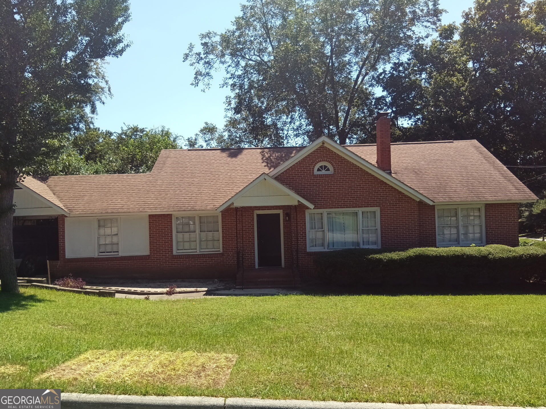SECTION 8 TENANTS WELCOME This solid four-sided brick home is located on a large fenced corner lot with mature landscaping and a producing pecan tree. Enjoy outdoor living on the rear patio, perfect for relaxation and entertaining. Inside, you'll find spacious bedrooms with original hardwood floors and a cozy wood-burning fireplace. The bonus room offers flexibility as a home office, den, or playroom. Additional features include a covered carport, laundry room, and two storage buildings. Major systems, including the roof and HVAC, have been updated in the last four years. This well-maintained rental offers timeless appeal and room to grow. Schedule a viewing today!
