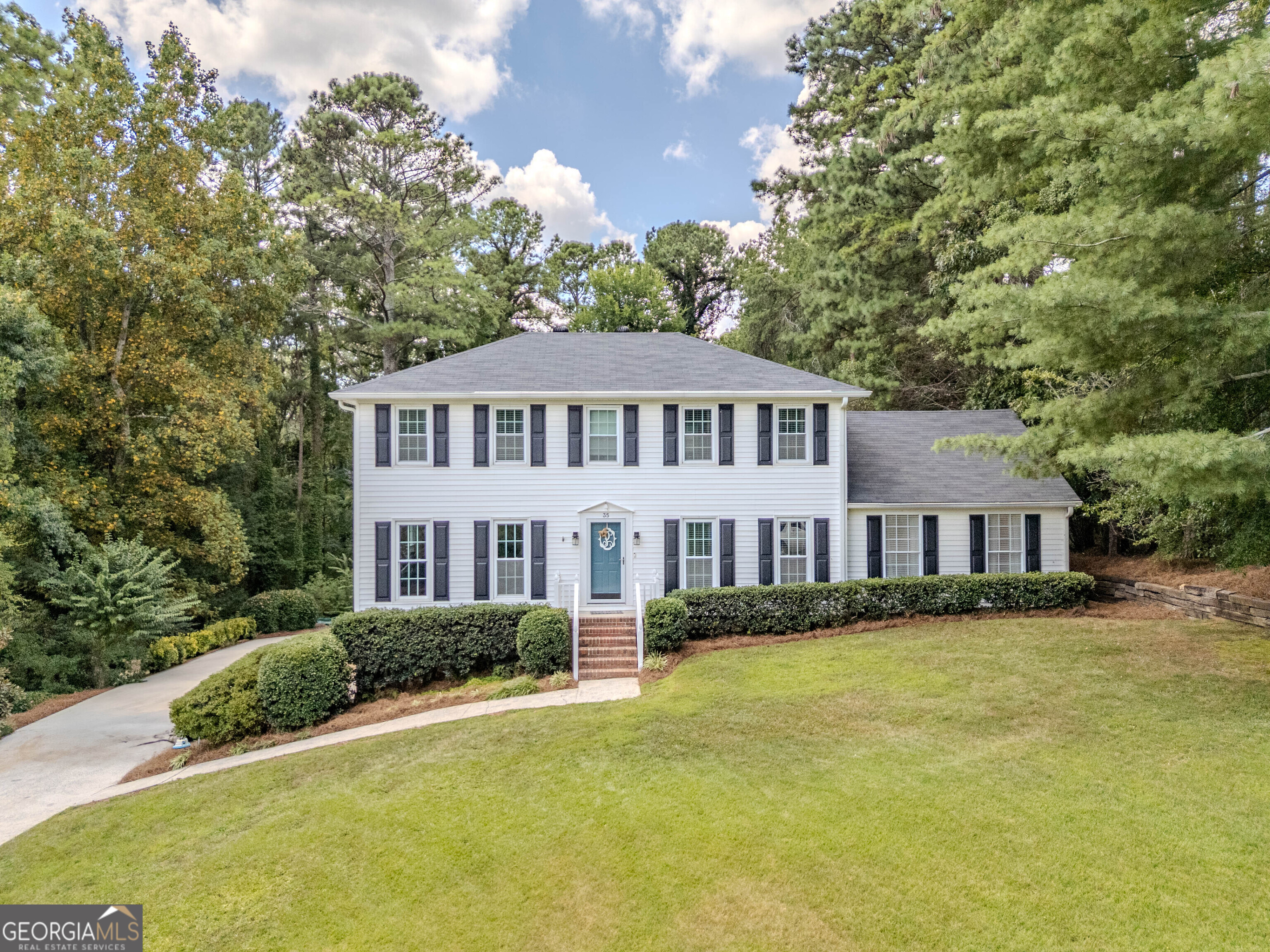 Wonderful large family home in Woodfin Estates! New roof, new tankless water heater, and an encapsulated crawlspace! On the main floor is a living room with floor to ceiling windows and a fireplace, office, kitchen and HUGE den with built-ins adjacent to a spacious sunroom. Upstairs are two bedrooms and a full bath in the hallway. The master has an en-suite bath and a large closet/office flex space. The basement is used as an additional guest bedroom with a closet and the laundry. The deck out back is the perfect place for entertaining. Raised beds and a small water feature (add your own fish!) make the backyard very inviting!