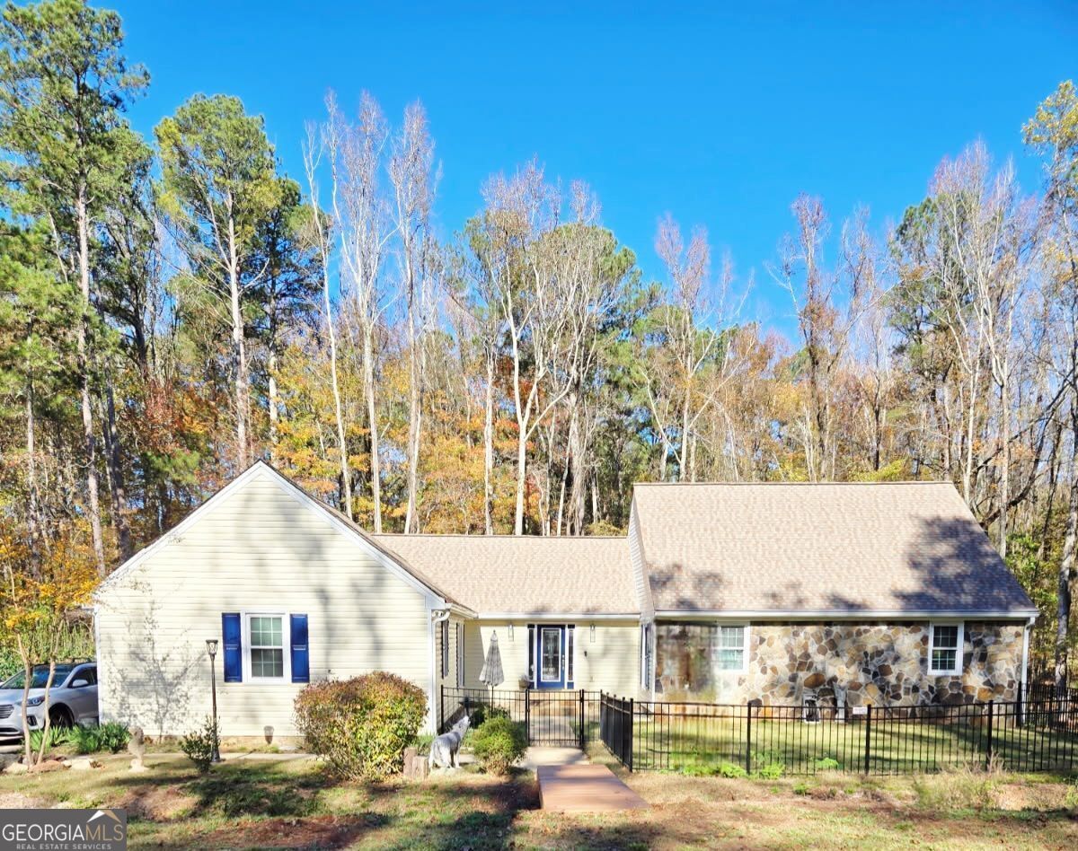 Welcome to this beautifully updated ranch-style home located in the desirable Whitewater School District. This property showcases numerous upgrades, including new windows, exterior doors, an HVAC system, insulation, light fixtures, and kitchen appliances. Additional enhancements feature a rebuilt main-level fireplace & both fireplaces have new inserts, professionally fenced front and back yards, and thoughtful landscaping for enhanced curb appeal. The main floor offers a gourmet kitchen with granite countertops, a central island, and brand-new appliances, seamlessly flowing to a dedicated dining room and a spacious family room with a brick fireplace that opens onto a serene, screened porch. The inviting entryway leads to a primary en-suite, two well-sized secondary bedrooms, and a generous hall bath. Upstairs, a versatile bonus room with a closet provides the option for a fifth bedroom or additional living space. A fully finished basement presents multi-generational living or rental opportunities with its own separate entrance, second kitchen, laundry room, expansive family room with fireplace, large bedroom, full bathroom, office or craft area, and abundant storage or workshop space. Outdoor living is equally impressive, with mature trees, picturesque landscaping, and fenced yards creating a private and peaceful retreat. This move-in ready home combines comfort, functionality, and exceptional value-ideal for discerning buyers seeking flexible living options. (Professional Photos Coming Soon, waiting for all the rain to stop!)