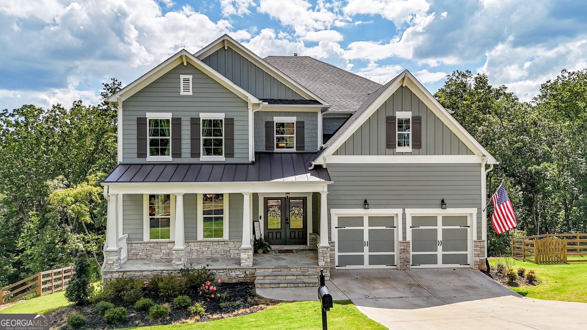 Welcome to this stunning 5-bedroom, 4-bathroom home built in 2022, offering modern elegance, thoughtful design, and a peaceful wooded backdrop with a creek running through the backyard. Step into the open foyer-offset to the formal dining room-and enjoy spacious living areas with hardwood floors, crown molding, and bay windows that fill the home with natural light. The formal dining room is set apart from the main living areas, creating a more defined and traditional entertaining space. The white-on-white kitchen features quartz countertops, stainless steel appliances, and a large island, all opening to the bright and inviting living room and breakfast area. A bedroom with a full bath on the main level is perfect for guests or multi-generational living. Upstairs, a spacious bonus room adds flexibility, while a Jack and Jill bathroom with a double vanity connects two secondary bedrooms. The primary suite is a luxurious retreat with double tray ceilings and a spa-like en suite featuring a soaking tub, oversized tiled shower, double vanities, and enormous his-and-hers walk-in closets. Enjoy outdoor living on the covered back deck with ceiling fans or step down to a second deck off the basement-ideal for enjoying the serene creek and wooded views. Additional highlights include a tile-floor laundry room, insulated garage doors, tankless water heater, and a full basement offering room to grow. This home blends comfort, quality, and privacy-perfect for modern living in a tranquil setting.