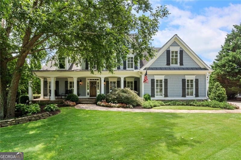 Welcome to 2429 Kirk Lane - A stunning Williamscraft Craftsman-Style Home in the Heart of Kennesaw, Georgia This expansive 7-bedroom, 5-bathroom residence blends timeless craftsmanship with modern luxury, offering an exceptional living experience in one of Kennesaw's most desirable communities. Situated on a beautifully mature landscaped lot, this home features a saltwater pool, spacious backyard, and exterior landscape lighting that highlights the architecture and enhances outdoor ambiance from dusk to dawn. Whether you're relaxing poolside or enjoying an evening gathering, the lighting creates a warm, inviting atmosphere across the yard, walkways, and covered patio areas. A gorgeous covered front porch welcomes guests into a double foyer designed by Wilmont Williams, opening into a thoughtfully designed open-concept living space. The main level showcases rich hardwood flooring and detailed crown molding throughout. The elegant formal dining room seats 12+ and flows seamlessly into the living room, which features vaulted ceilings, custom built-in bookcases, and a stacked stone fireplace with views of the covered rear porch and beautifully lit backyard. The gourmet kitchen is equipped with modern Jenn-Air appliances, Light custom cabinetry, granite countertops, and both a breakfast bar and eat-in area-ideal for cooking and entertaining. The primary suite on the main level includes a luxurious porcelain-tiled shower, whirlpool tub, custom walk-in closet, and direct access to the rear covered porch. An additional bedroom with en-suite bath and a dedicated office complete the main level. Upstairs, you'll find four generously sized bedrooms, including a Jack-and-Jill bathroom, a private en-suite, and a flexible bonus space perfect for a home gym, additional office, or guest retreat. The fully finished terrace level is an entertainer's dream, featuring 10'+ ceilings, elegant crown molding, hardwood floors, and a custom-built bar with an ice maker, dishwasher, multiple refrigerators, and keg tap. Additional highlights include a recreational space with pool table and arcade games, an impressive wine cellar, a spacious bedroom with a full bath, ample storage, and a dedicated workshop. The backyard oasis is perfect for relaxation or entertaining, complete with a saltwater pool, hot tub, raised garden beds, green space, and strategically placed exterior lighting that enhances the overall ambiance well into the evening hours. Located near Kennesaw Mountain National Battlefield Park, downtown Marietta, Marietta Country Club, and a variety of dining, shopping, and recreation options, this home offers the perfect balance of functionality and luxury living.