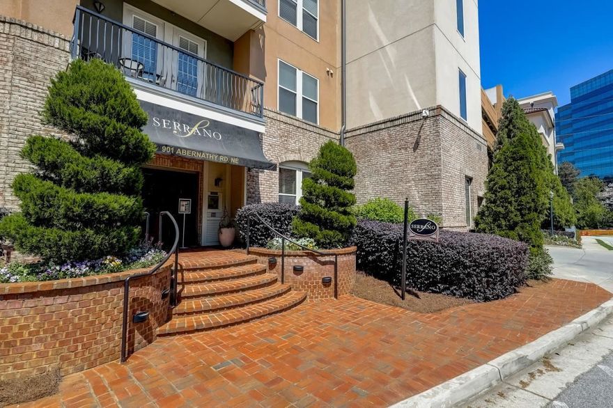 Immaculate, one owner, fifth floor spacious condo in the prestigious Serrano. Amazing location directly across from Mercedez Benz Headquarters, & convenient to everything Sandy Springs has to offer. Private balcony provides a stunning sunset view! Open floor plan w/ hardwood floors, granite countertops, breakfast bar, stainless appliances, built-in wine rack, & laundry room. Lobby level offers easy access to resort style amenities including pool, clubhouse, theater room, & state-of-the art fitness center. Rare side-by-side, 5th floor deeded parking spots so you do not have to get on the elevator to access your home. Seconds to 400, 1/2 mile to MARTA rail, & minutes to Perimeter mall.