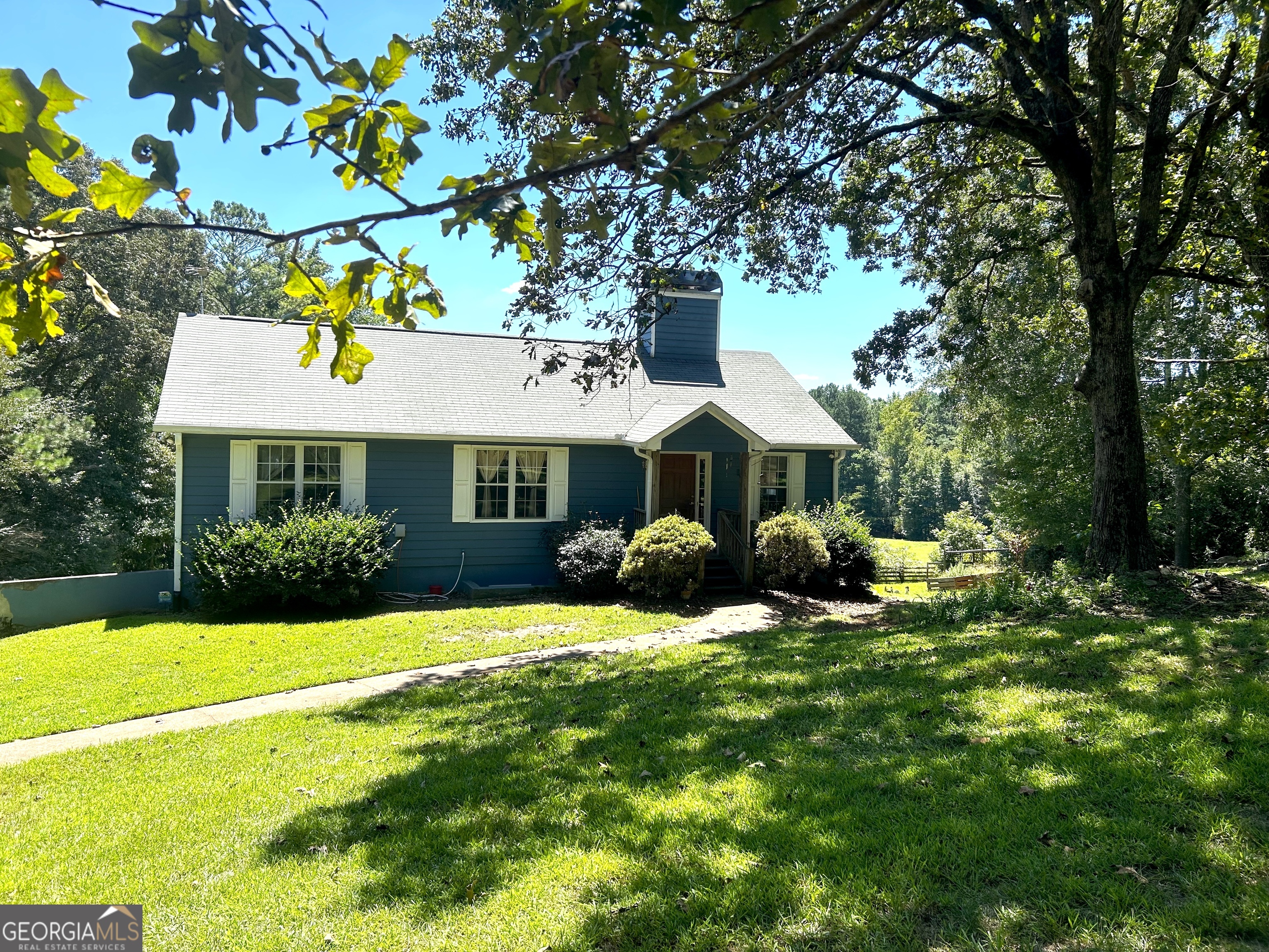 Welcome Homesteaders, Farmers, Ranchers, anyone who loves nature and privacy on 14.79 acres! Rest your soul in this peaceful environment. This property has been used for growing a vegetable garden, rescue horses, dogs and raising chickens and walking trails. You really must walk the whole property to see to accept the tranquility of the property as is or the outstanding, unlimited potential to make it exactly what you dreamed. Most of the land is cleared and ready for any project. The whole perimeter of the property is fenced and there are additional fencing to separate the yard from the pasture so it really is your own private setting. Enjoy the fruit trees: blueberries, elderberries, fig, pear, muscadine. The 5 spring fed springs will help hydrate your animals and plants. There is also a barn and multiple outbuildings and sheds for storage and equipment. Turn these into a workshop or whatever your heart desires since they have access to power with a generator. TOTAL SQ FT = 2011 which includes the below ground level. Walk in the front door to find a cozy living room with a double-sided fireplace that supports the large office, game room, fitness room or playroom behind it. Go down the hall to the guest bedroom with a full shower/tub bath across the hall. The large primary bedroom has its own large walk-in closet and full bath with an extra-large walk-in shower. You may choose to use the finished daylight basement as your primary living space or for your extended family. You can park at this level and walk through the French doors into a bedroom. A full tub/shower bath is down the hall. The Kitchen is fully equipped with lots of cabinet and counter space with rollable island. It shares the double-sided fireplace with the connecting family room. Another gathering space is the separate dining room and enclosed screened-in porch for viewing your back yard or step just outside to the patio and soak in your hot tub to relax those muscles. This home even has outdoor showers to clean your boots. This home is within 4 miles of I-20 and centrally located between Bremen, Temple and Carrollton where there's a variety of shopping, dining, churches and schools so you could have the best of both worlds with a rural setting close to places you need. Come see what the possibilities could be for your lifestyle that only this land can produce.