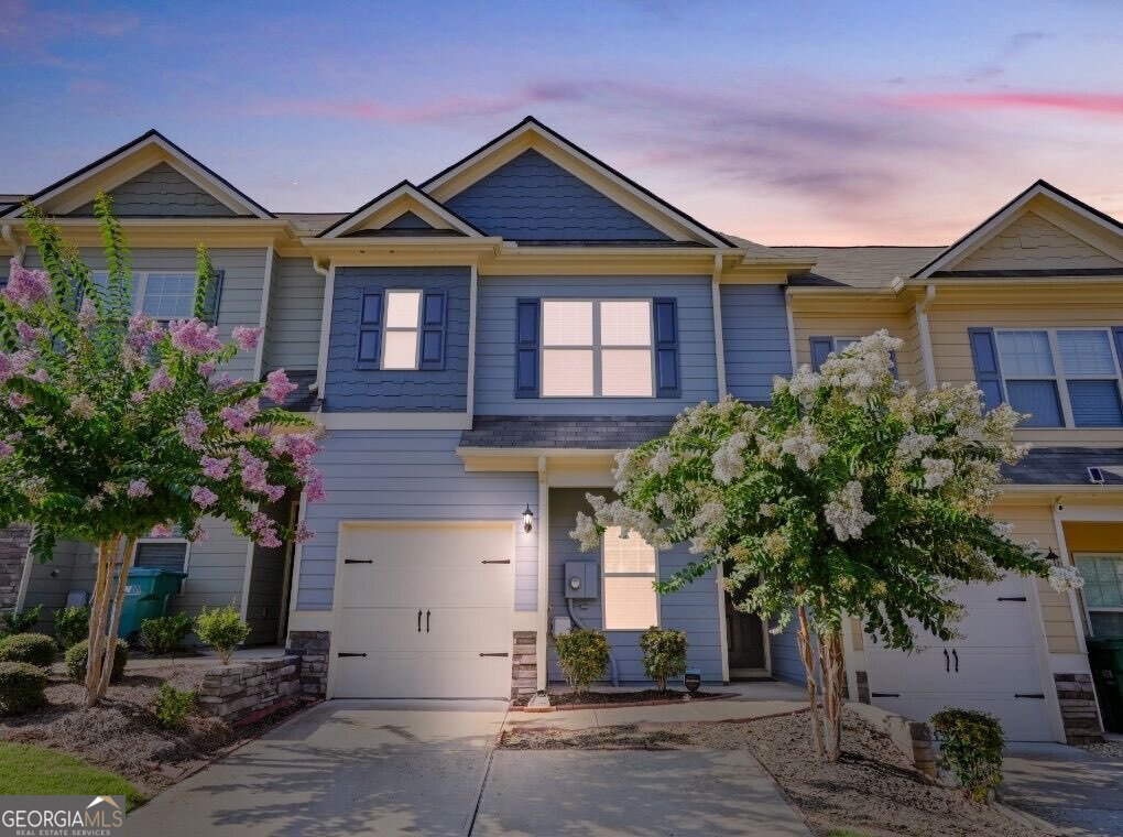 Prepare to be charmed by this beautifully maintained craftsman-style townhome, built in 2020 and located in one of the area's most desirable communities-where the amenities are as fabulous as your favorite brunch spot (minus the long wait times). Enjoy resort-style living with a swimming pool for those summer cannonballs, tennis courts to unleash your inner Serena, a friendly clubhouse perfect for mingling, a lively playground for the kids to burn energy, and even a dog park so your pup can finally make some four-legged friends. Inside, the layout is open and inviting. The spacious main floor flows effortlessly and includes a bonus flex space-ideal for a home office, study nook, or that sacred "do-not-disturb" zone. Upstairs, you'll find a large primary suite with soaring ceilings, two generous secondary bedrooms, and a convenient laundry area, so you can finally stop trekking downstairs in mismatched socks. With 2.5 bathrooms, a one-car garage, and driveway parking for two more vehicles, this home checks both the style and practicality boxes. The private concrete patio is perfect for relaxing outdoors or hosting a casual weekend cookout-BYOB (Bring Your Own Burgers). Bonus: yard and grounds maintenance are included, meaning you can spend weekends relaxing instead of waging war with the lawnmower. Located just minutes from I-575 and a short drive to Woodstock, Canton, The Outlet Shoppes at Atlanta, The Mill on Etowah, and Canton Marketplace-plus great parks and trails. This home makes it easy to love where you live, blending charm, comfort, and convenience in one perfect package.