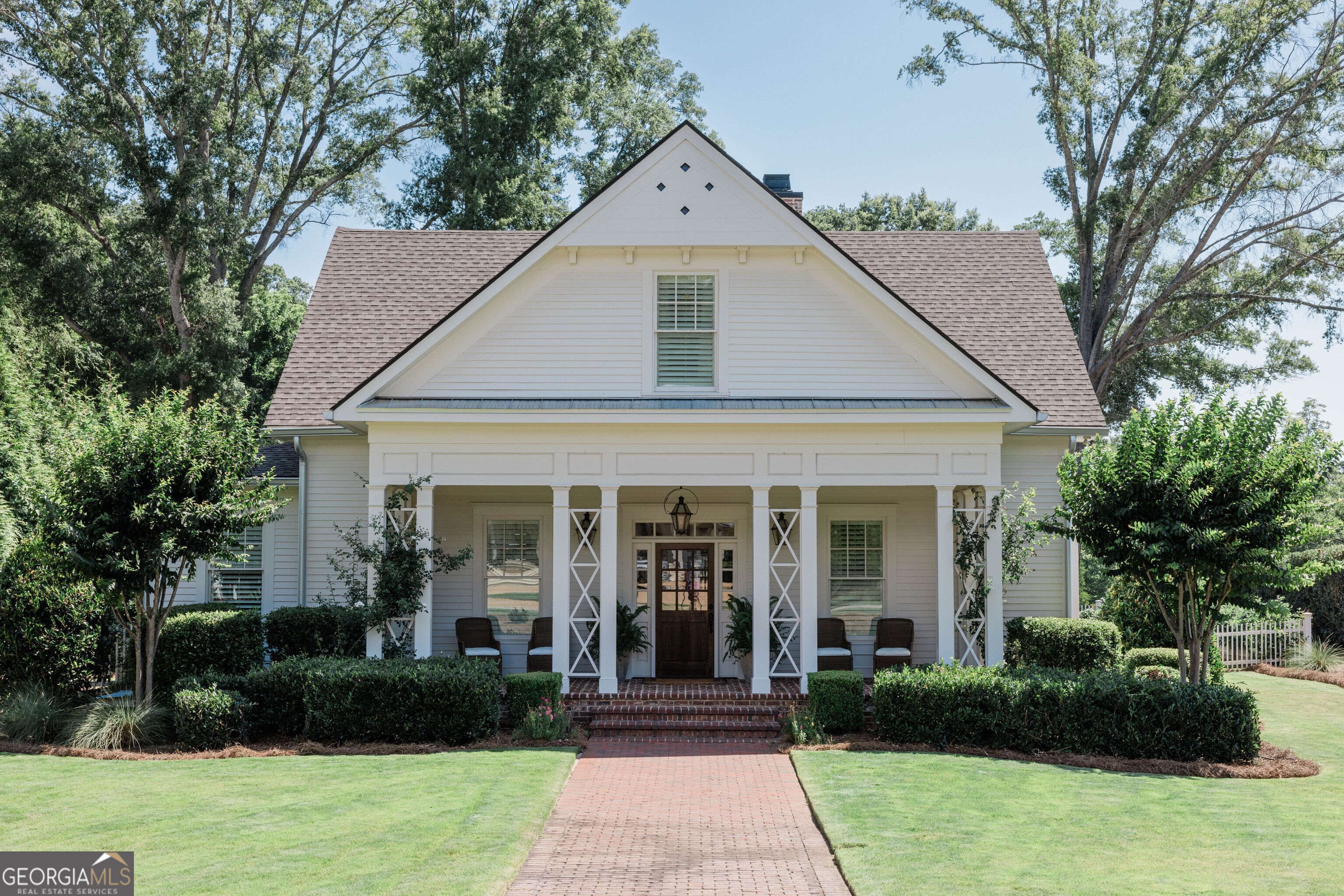 Custom-Built Luxury in the Heart of Madison - Walk to Town! Discover refined Southern living in this one-of-a-kind 4 bedroom, 3.5 bath custom-built home located within the city limits of Madison-just a short walk from the historic town square, shopping, dining, and community events. From timeless architectural details to thoughtful high-end finishes, every inch of this home exudes craftsmanship and comfort. Step inside to find gleaming hardwood floors throughout, leading you into a chef's kitchen that's the heart of the home. Outfitted with top-of-the-line stainless steel appliances, expansive marble countertops, custom cabinetry, and a spacious island, it's designed for both entertaining and everyday luxury.The primary suite is located on the main level and serves as a true retreat, featuring a spa-like bathroom with a freestanding soaking tub, walk-in marble shower, and elegant finishes. Upstairs, you'll find two generously sized bedrooms connected by a stylish Jack and Jill bathroom, perfect for family or guests.This home is filled with custom features you won't find elsewhere- detailed millwork, shiplap, antique barn doors and custom light fixtures. Step outside to find the immaculately landscaped yard with established Zoysia sod and a 6-zone irrigation system fed by a private irrigation well. The entire main level seamlessly flows onto a blue stone-covered porch with an outdoor fireplace, fully equipped outdoor kitchen, gas lanterns and a resort-style pool and gas heated spa-ideal for summer relaxation or year-round entertaining. Also included is a luxury pool house with a full bath, perfect for a home gym, office, or private guest quarters-providing ultimate flexibility for your lifestyle needs. Wine connoisseurs will be happy to find a unique custom built, climate controlled wine cellar. This is more than just a home-it's a rare blend of location, quality, and luxury. Homes like this don't come on the market often. Schedule your private showing today! Showings start Friday, July 11th.