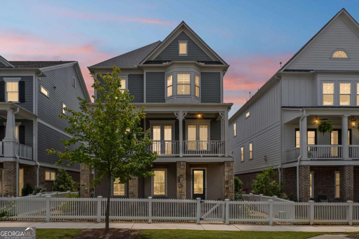 Experience Elevated Living at South on Main - Downtown Woodstock's Most Coveted Luxury Community. Welcome to your dream home in the heart of vibrant Downtown Woodstock! Nestled in the premier South on Main neighborhood, this impeccably designed, nearly new 3-story masterpiece is just steps from top-tier restaurants, boutique shopping, and year-round events. Built only 2 years ago and packed with luxury upgrades, this home seamlessly combines modern sophistication with timeless elegance. Boasting 4 spacious bedrooms, 4.5 designer baths, and your very own private elevator, this residence is built for effortless entertaining and everyday ease. The main level offers a fluid open-concept layout adorned with rich hardwoods, custom molding, and designer finishes throughout. Enjoy a dedicated home office, a refined formal dining room, and a warm, inviting family room with a fireplace featuring a custom mantel and bespoke trim work. The chef's kitchen is a true showpiece, equipped with Silestone Cosentino quartz countertops, a high-end Thermador range, custom vent hood, waterfall-edge island, quartz backsplash, a stainless apron-front sink, built-in microwave, and soft-close cabinetry-a dream for culinary enthusiasts. Upstairs, retreat to your luxurious primary suite featuring a spa-like ensuite with soaking tub, quartz counters, oversized walk-in shower, and designer tile selections. The terrace level includes a generously sized flex room with a full bath-ideal for guests, a gym, or a private workspace. Step outside and enjoy two fabulous outdoor spaces: a covered front porch with Trex decking overlooking community gardens and firepits, and a freshly stained wraparound back deck perfect for evening gatherings under the stars. Additional features include: Custom blinds and roller shades, Designer lighting throughout, 3-car garage with professional epoxy floors, Whole-house water filtration system and Professionally landscaped grounds. South on Main offers unmatched community amenities: a resort-style pool, clubhouse, fitness center, two dog parks, an amphitheater, and a full calendar of concerts, festivals, and neighborhood events. Direct access to the Noonday Trail adds even more to love. Skip the wait and expense of new construction-this turnkey, gently lived-in home is move-in ready and brimming with upgrades you won't find elsewhere. Schedule your private tour today and experience the best of Downtown Woodstock living!