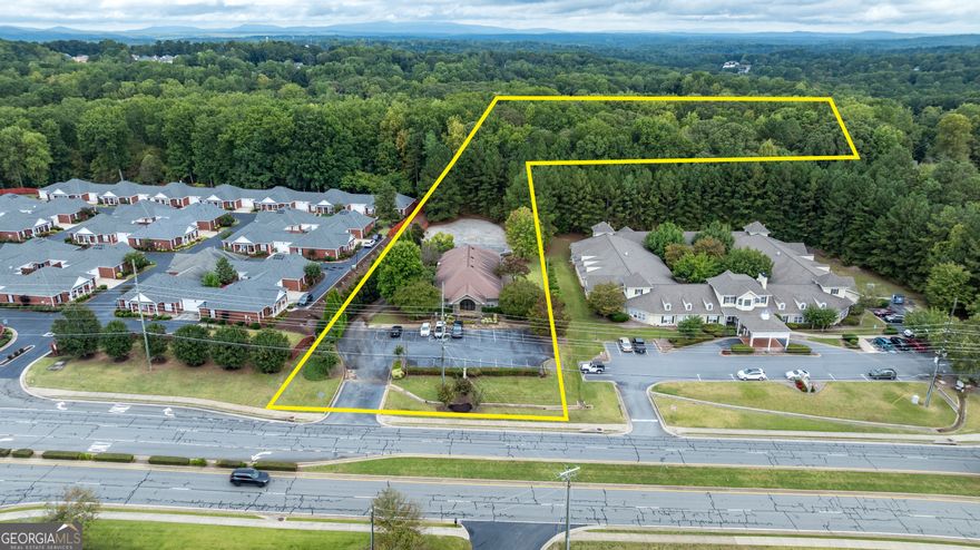 Exceptional Commercial Opportunity with Dual-Zoned Acreage in Cherokee County  Discover a rare investment and business opportunity with this beautifully renovated 4,600 sq. ft. commercial building situated on 1.23 acres-plus an additional 2.02-acre adjoining lot included in the sale. Ideally positioned in Cherokee County, this property offers incredible flexibility with dual zoning: PUD on the primary parcel and OI on the adjacent land, opening the door for a wide variety of commercial, professional, or mixed-use applications.  Step inside to find a fully renovated interior featuring stunning hardwood floors, a welcoming lobby, a large open workspace with cubicles, and private offices that balance function with comfort. The break room includes a full kitchen, perfect for team lunches or client hospitality, and the expansive rear room provides space for collaboration or training.  Outside, the property shines with a beautiful outdoor area ideal for breaks, company events, or casual gatherings-adding a touch of lifestyle appeal to a professional setting. The additional 2.02-acre parcel offers room for future expansion, parking, or development opportunities.  Whether you're looking for an office headquarters, professional services space, or a flexible commercial investment, this property provides the space, style, and zoning versatility to make your vision a reality.