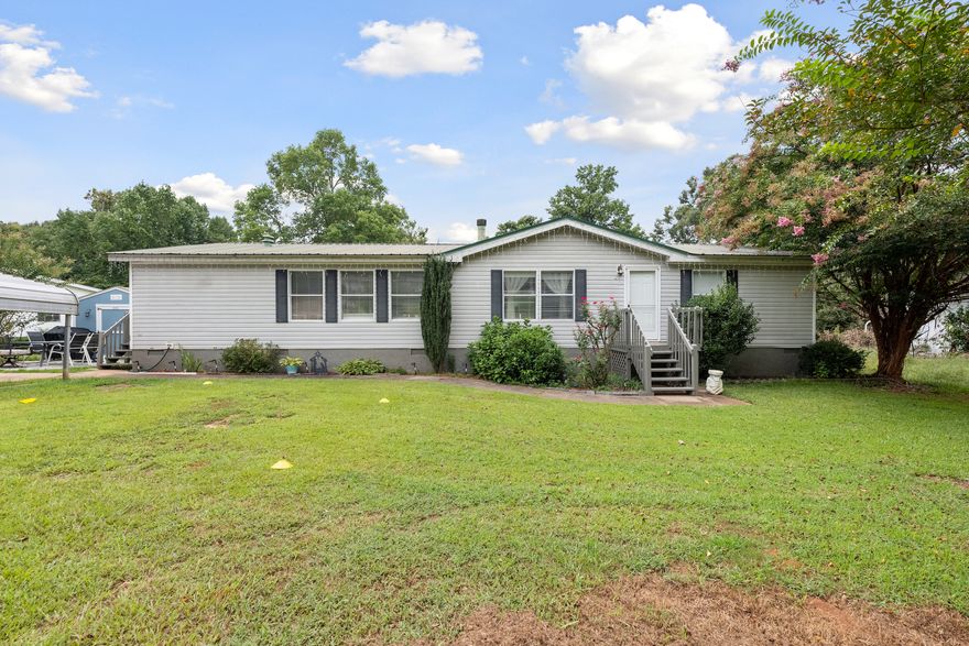Great opportunity for a great value in Sought After Cherokee Bluff School District!  Large 3 Bedroom Mobile home that has been well cared for!  Spacious Kitchen boasting White Cabinets, Gas Range, Island with Breakfast Bar, Sunny Breakfast Area, and Pantry!  Huge Family Room with Vaulted Ceilings and Fireplace!  Newer Carpet!  Split Bedroom Plan!  Large master with Walkin Closet and remodeled Master Bath featuring Double Vanities, Shower and more closet space!  Laundry Room has a great storage room/Pantry and door leading to the exterior of the home!  Covered Rear Porch!  Private Backyard!  Detached Carport Stays!  Very Clean Home.