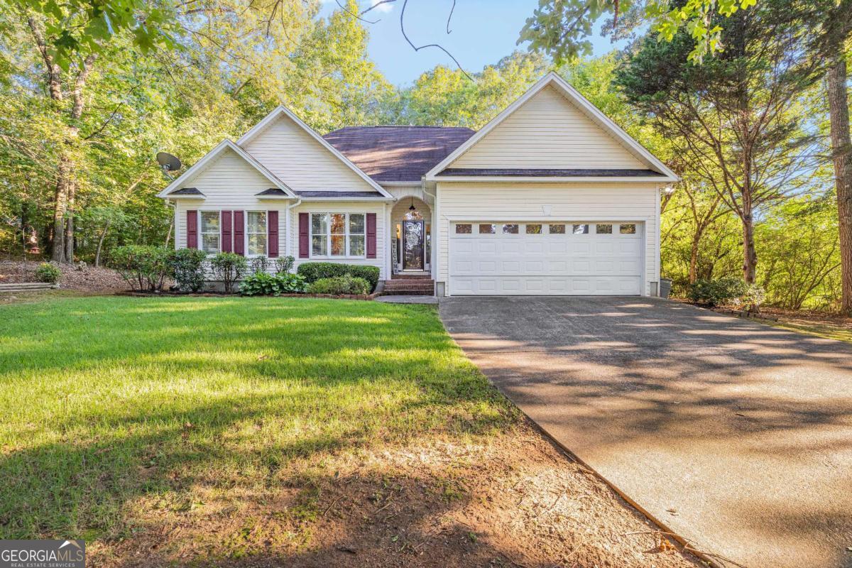 Ranch Home on Private, Wooded Lot in a Sought-After Neighborhood! Tucked away in a serene setting within one of the area's most popular neighborhoods, this charming 3-bedroom, 2-bath ranch combines comfortable living with a peaceful, wooded backdrop. A welcoming front porch and manicured landscaping set the tone, leading into a bright, open floor plan with vaulted ceilings and warm hardwood floors in the main living areas. The spacious great room offers a cozy fireplace and flows easily into the dining area and kitchen, making it ideal for entertaining. The kitchen features white cabinetry, ample counter space, a breakfast bar, and a bay-window breakfast nook overlooking the backyard. The private primary suite boasts a tray ceiling, direct access to the back porch, and an en-suite bath with a jetted soaking tub, and separate shower. Two additional bedrooms share a full bath. Enjoy the outdoors from the freshly painted back deck, perfect for grilling or relaxing while taking in the tree-lined views. The level backyard provides space for play or gardening, framed by mature shade trees for privacy. Additional highlights include a two-car garage, abundant storage, and a prime location close to shopping, dining, and schools. This well-maintained home offers the perfect blend of comfort, convenience, and a highly desirable location-ready for you to move in and make it your own.