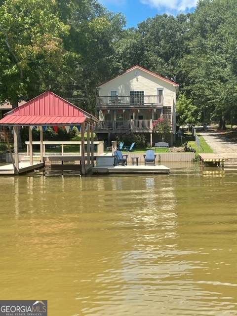 Wonderful house on deeded lot, waterfront on Jackson Lake. The interior has been updated and all furnishings are included. The property has been operating successfully as an AIRBNB, and also is well appointed to be a full time residence. The lot is relatively flat with a gentle slope to the lake. The two-level deck provides a great lake view and is perfect for relaxing. You will enjoy the sun dock and covered boat slip. The fall season is beautiful at Jackson Lake with moderate temperatures and colorful leaf foliage. Don't miss out on this gem on Jackson Lake!