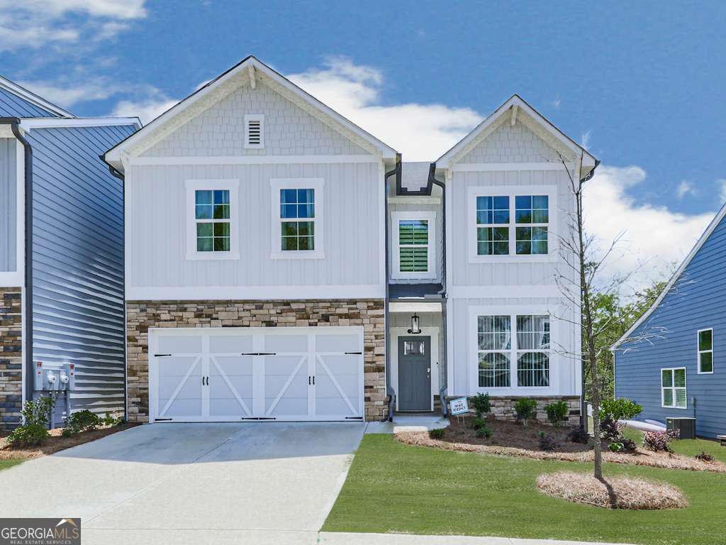 Welcome to your dream home in the sought-after Great Sky subdivision! This stunning 2023-built home offers over 2100 sq ft of modern living with timeless charm ONLY ATTACHED by the mudroom wall (other than that the home has NO common walls with another home). Featuring a master suite on the main level with a luxurious master bath and spacious walk-in closet, this home is designed for comfort and convenience. The open-concept layout showcases a beautifully upgraded kitchen with a large island, perfect for entertaining or casual dining. Additional highlights include a two-car garage, main-level laundry with a mudroom area, and an upgraded flex space ideal for a home office or formal dining room. Upstairs, you'll find two generously sized bedrooms, a large full bathroom, and a versatile bonus room that can serve as an additional bedroom, office, or ample storage space. What truly sets this home apart is the rare backyard-one of the few in the Lakeside Pod in Great Sky-overlooking the serene lake. Custom stairs lead you down to the water, making it the perfect spot to unwind and enjoy nature. With custom accent walls and designer lighting throughout, this home is move-in ready and radiates style in every corner. Also, Gamechanger, the HOA takes care of your lawn Maintenace including mowing your grass, fresh pine straw, etc. so you do not have to worry with it! Don't miss the opportunity to own this unique gem in Great Sky!