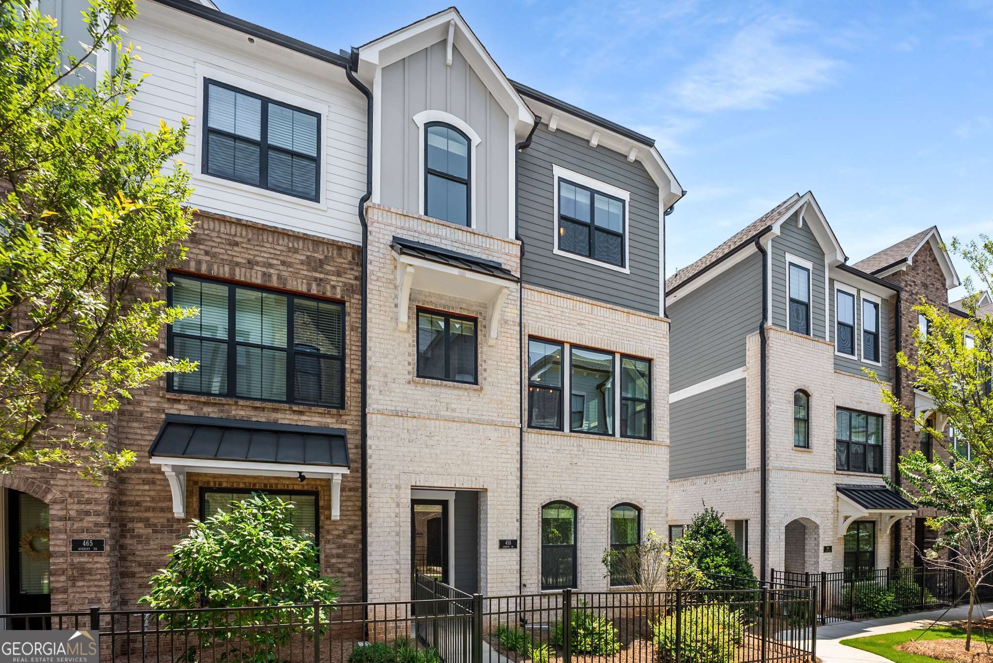 Wow!! Gorgeous end unit townhouse, 1 year new located in the perfect gated community in Roswell. This unit is quite the showstopper for sure. Completely open floor plan on main level. Gorgeous kitchen with quartz counter tops, stainless built in appliances, tiled backsplash, 5 burner gas cook top and white cabinets. Open family room with decorative accent wall molding. Lower level bedroom with full bathroom, great for guests. Nicely sized owners suite with decorative accent wall molding and awesome owners suite bathroom. 2 additional nicely sized secondary bedrooms. Laundry room up with brand new washer and dryer included as well as a stainless refrigerator. 2 car rear facing large garage. The complex is completely gated and offers a pool with cabana and dog park. It's situated minutes from downtown Roswell, Alpharetta and Avalon. GA400 is literally 5 minutes away.