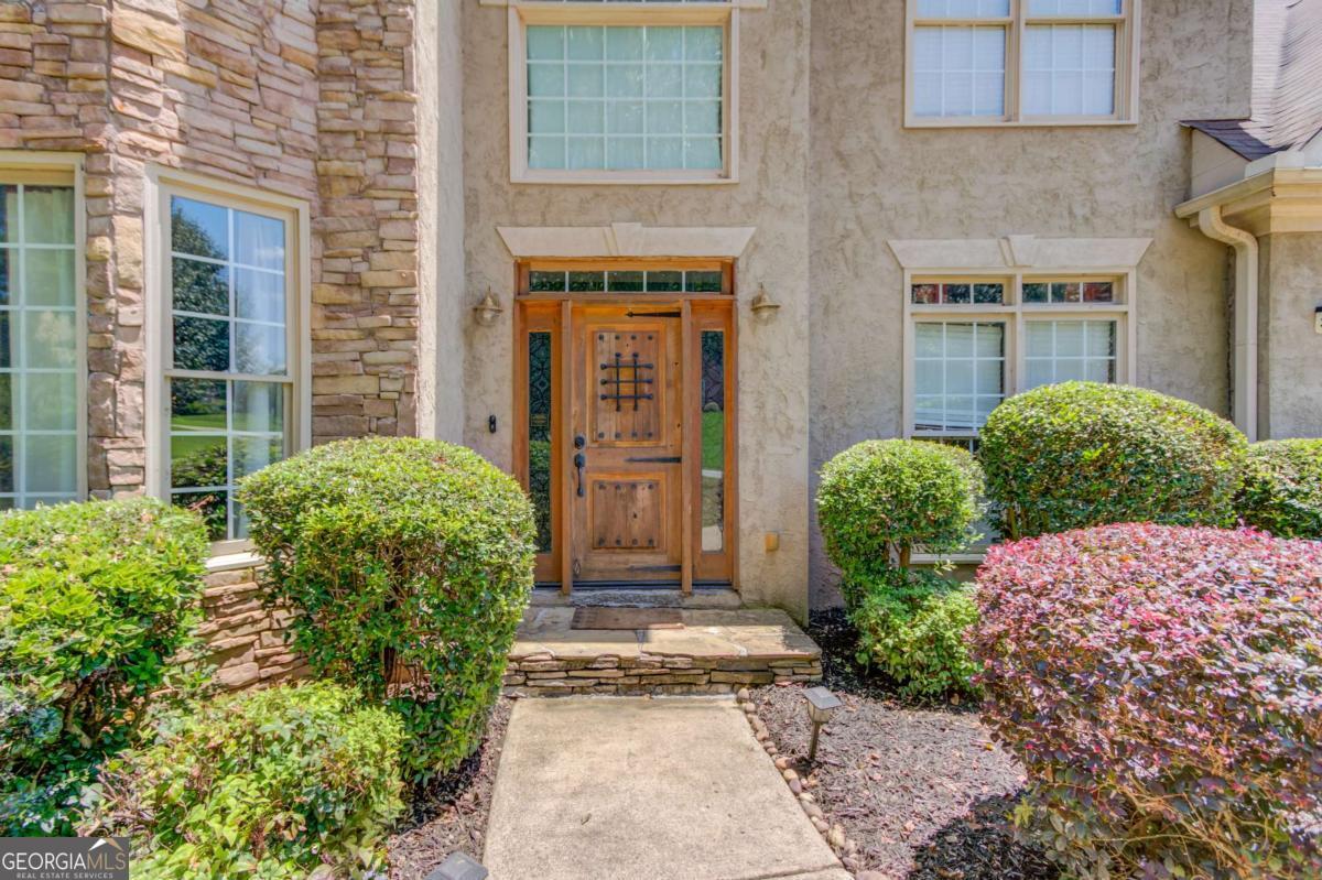 Welcome to this light-filled 5-bedroom, 3.5-bath home designed for comfort, versatility, and entertaining. Step inside to a dramatic two-story foyer and living room that create an open, airy feel. The main level features a flex space perfect for a home office or playroom, a separate dining room for formal gatherings, and a bright breakfast area with a breakfast bar overlooking the kitchen. Enjoy cooking in the kitchen outfitted with new stainless steel appliances and flowing into the living area-both along with upstairs recently updated with luxury vinyl plank (LVP) flooring for a stylish, low-maintenance touch. Upstairs, you'll find generously sized secondary bedrooms and a large primary suite with a private sitting room-ideal for unwinding after a long day. The finished walkout basement includes a full second kitchen, laundry area, full bathroom, bedroom with 2 additional rooms ready for a workout room, playroom, home office - so many possibilities and it has a private entrance-perfect for multi-generational living or potential rental income. Outside, the fenced, level backyard is beautifully landscaped and features a generous deck-ideal for weekend BBQs and gatherings. The front yard features professional landscape uplighting, adding curb appeal and charm after sunset. Located in a welcoming, well-maintained neighborhood, this home is move-in ready and offers flexible living options to fit your lifestyle.