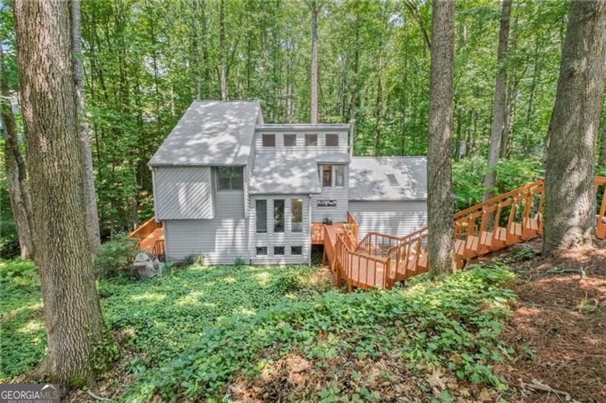 Escape the hustle and bustle of East Cobb nestled in your own private wooded retreat located at the end of cul de sac. This 4 bedroom 3.5 bath home located in East Cobb coveted trifecta of schools is now available for immediate occupancy. Spacious Eat in Kitchen has been renovated with up to date style and large island topped with all stone counters, deep sink, modern faucet, stainless steel appliances and range hood all top hardwood flooring. Incredible great room with vaulted ceilings floor to ceiling fireplace and abundant windows and skylights contribute to the open and airy contemporary feel. Hard to find primary ensuite on main level includes fireplace, hard woods and plenty of room for separate seating area surrounding the fireplace. Primary bath has a complete renovation with deep soaking tub separate tiled shower ad dual vanities. Head upstairs where you find 2 generous sized bedrooms connected by shared bath in addition to a versatile windowed loft area on the opposite end of the 2nd floor. The terrace level continues with generous rooms and has a great family room with a wet bar too.Loads of space for all the your recreation fun. Additional 4th bedroom with adjacent full bath provides multiple options for use such as a home office, gym or guest room. Mutiple access across 2 levels of the home to wrap around decking provides wonderful views of your large private lot and also provides plenty of space for entertaining. Newer roof, HVAC and water heater Home has just been refreshed with paint and newly installed carpet. Driveway Retaining wall replaced just this month Garage has been outfitted for EV charging  Make your move and enjoy the full amenities the community provides for the whole family!